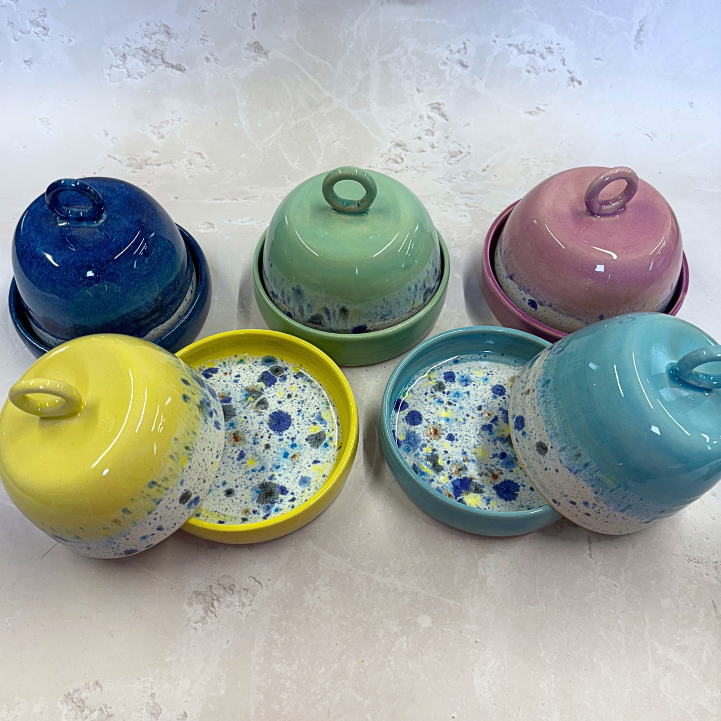Ella Fletcher Designs Handmade Ceramic Butter Dishes in Shoreline Range, five butter dishes in the range of shoreline colours - navy, green, pink, yellow and blue