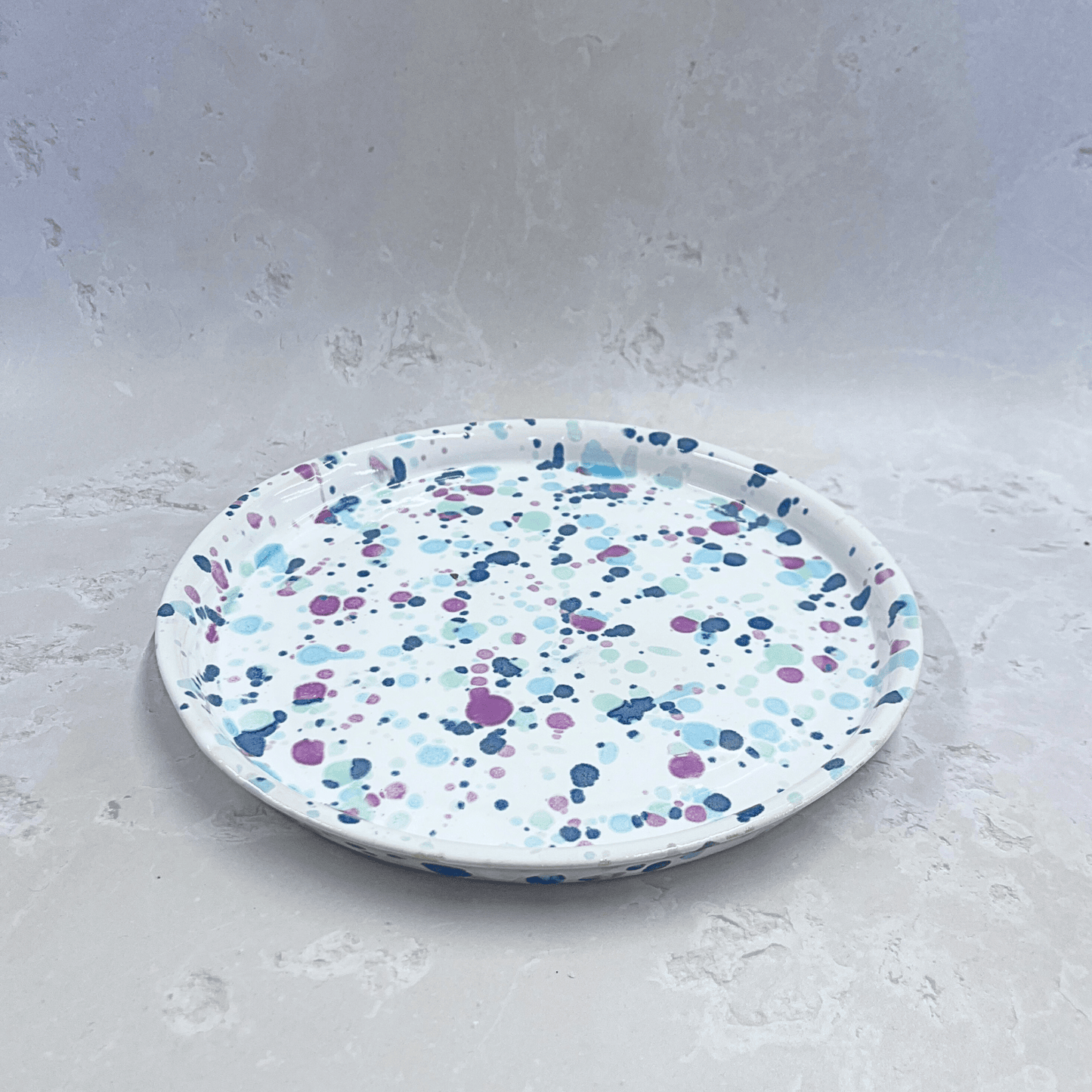 Ella Fletcher Designs Handmade Ceramic Dinner Plate in Sweetpea, circular plate with white background speckled with pinks and blues to resemble a sweet pea flower