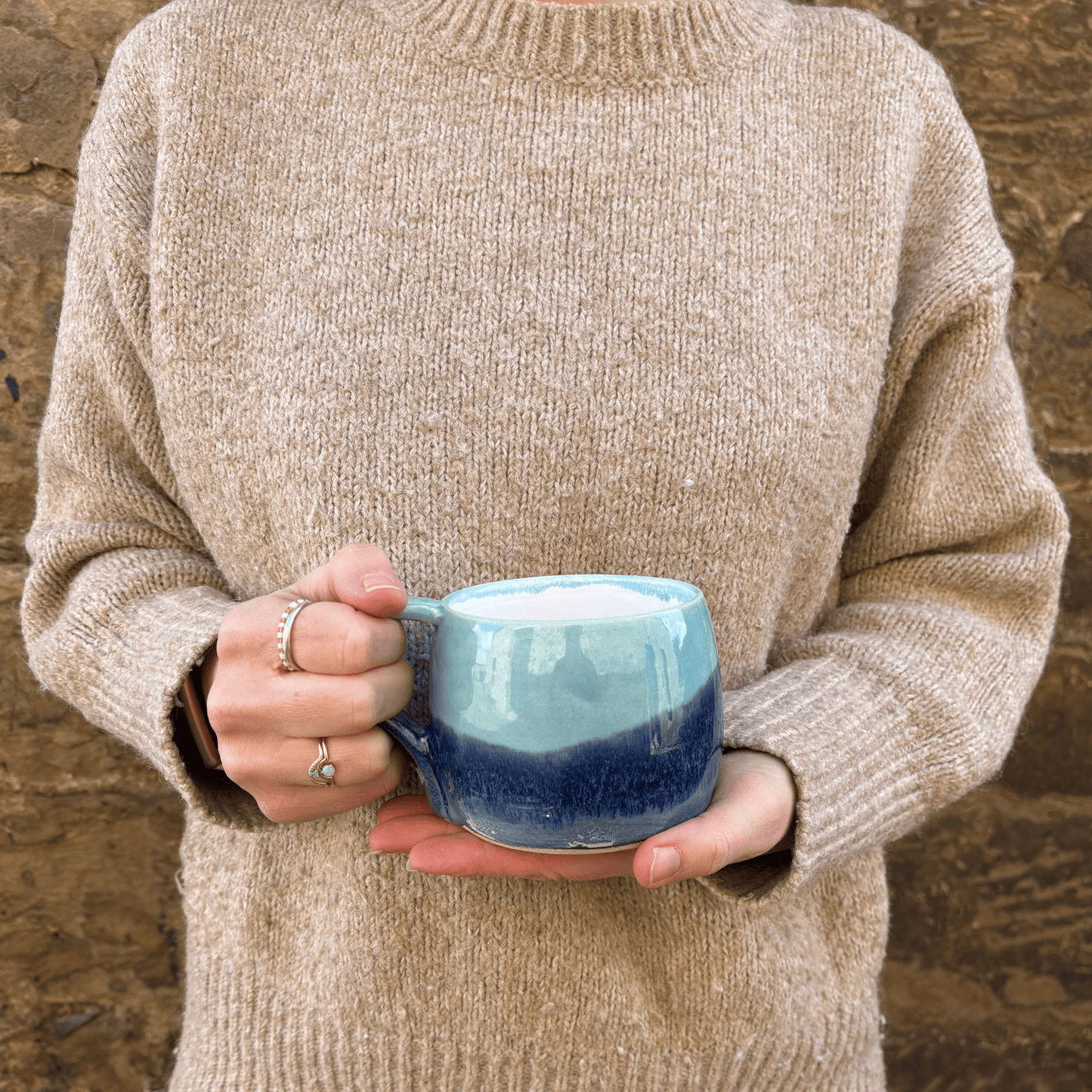 Ella Fletcher Designs Handmade Ceramic Large Round Mug in Pink Landscape design, large mug being held featuring layers of light and dark blues
