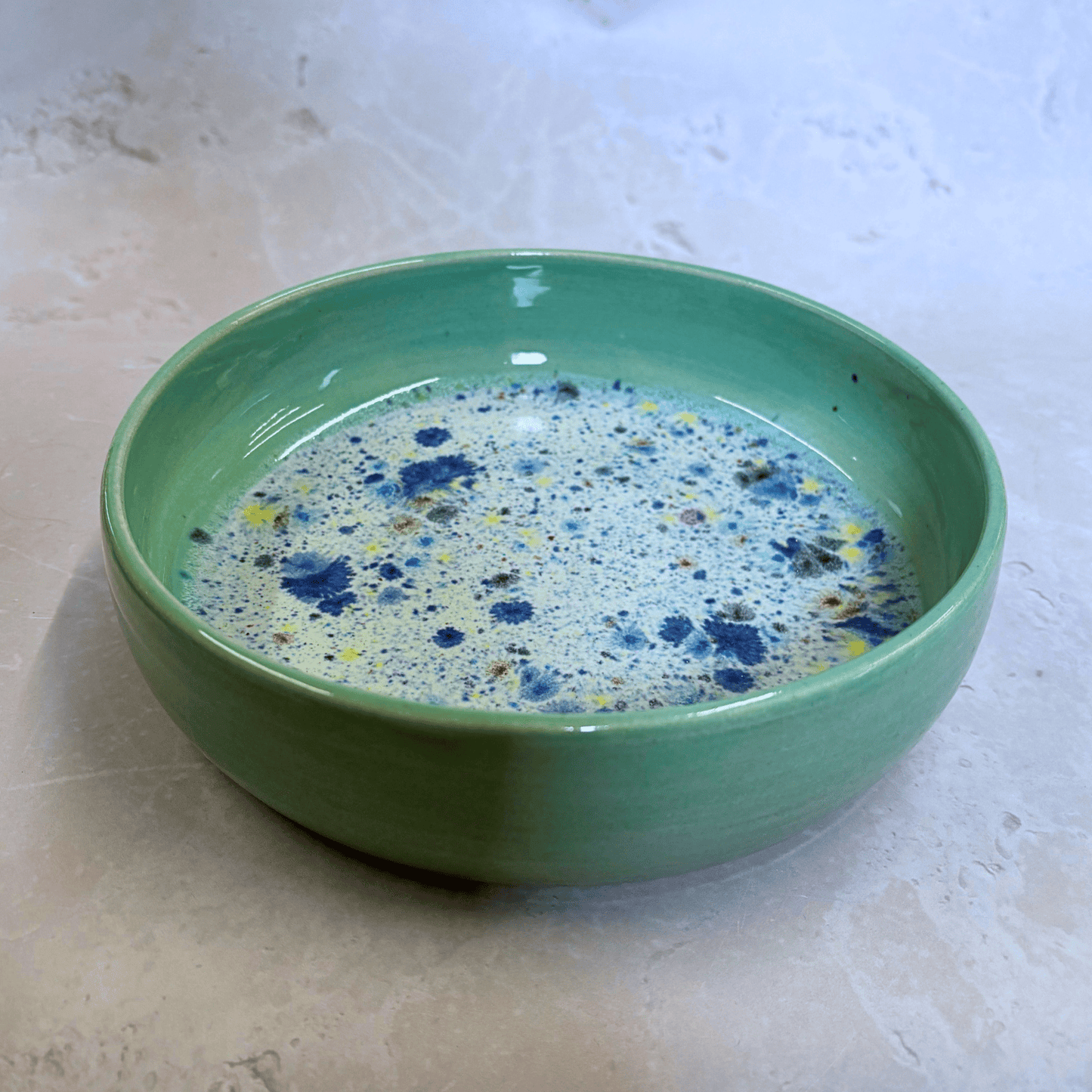 Ella Fletcher Designs Handmade Ceramics Pasta Bowl in Green Shoreline, green rimmed pasta bowl with multicoloured speckles inside