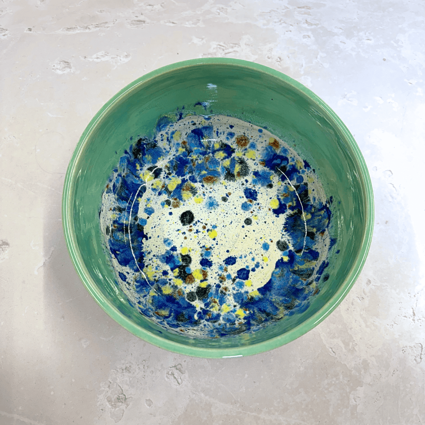 Ella Fletcher Designs Handmade Ramen Bowls in Green Shoreline, bowl with solid green melting into multi-coloured speckles on a white background