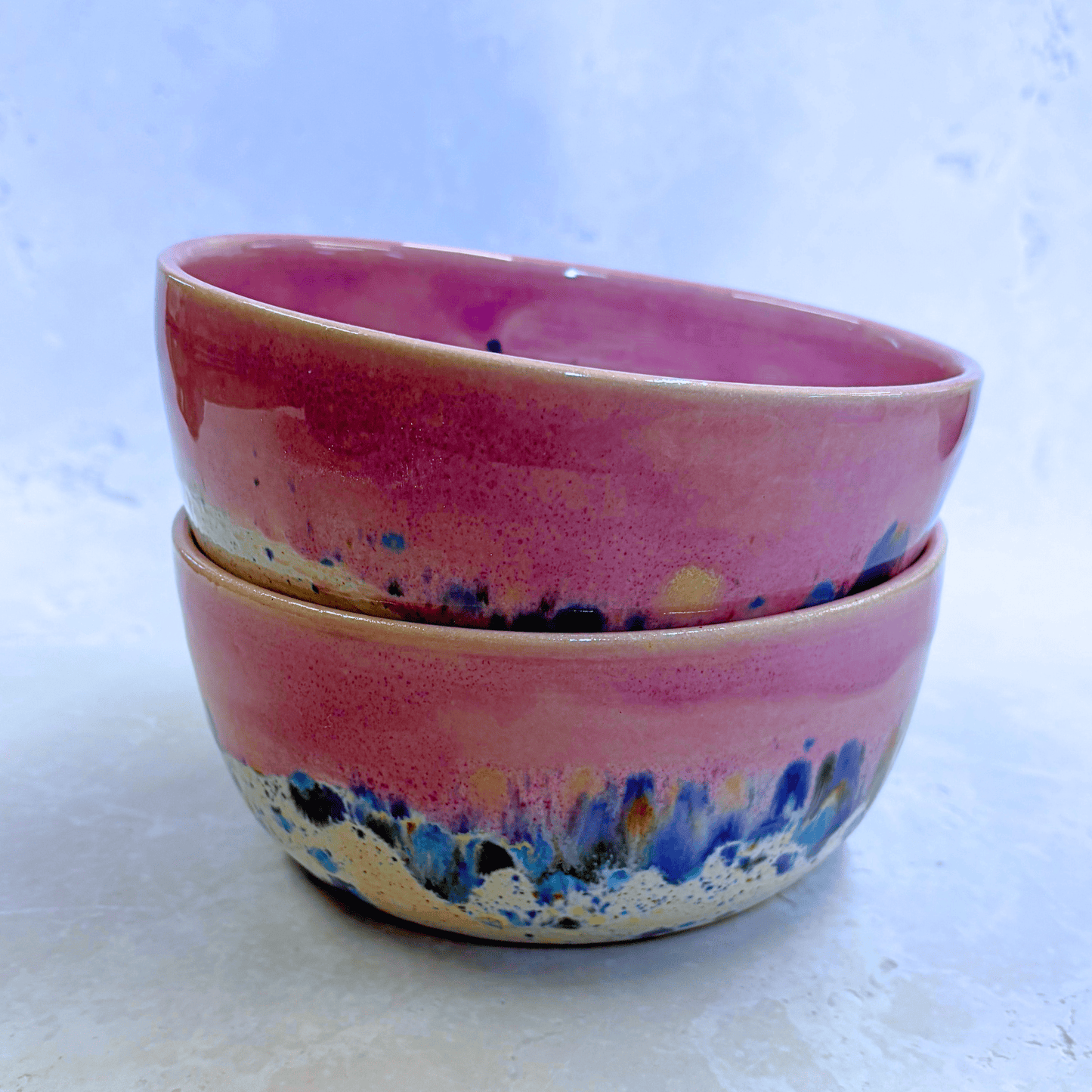 Ella Fletcher Designs Handmade Ramen Bowls in Pink Shoreline, bowls stacked with solid pink melting into multi-coloured speckles on a white background