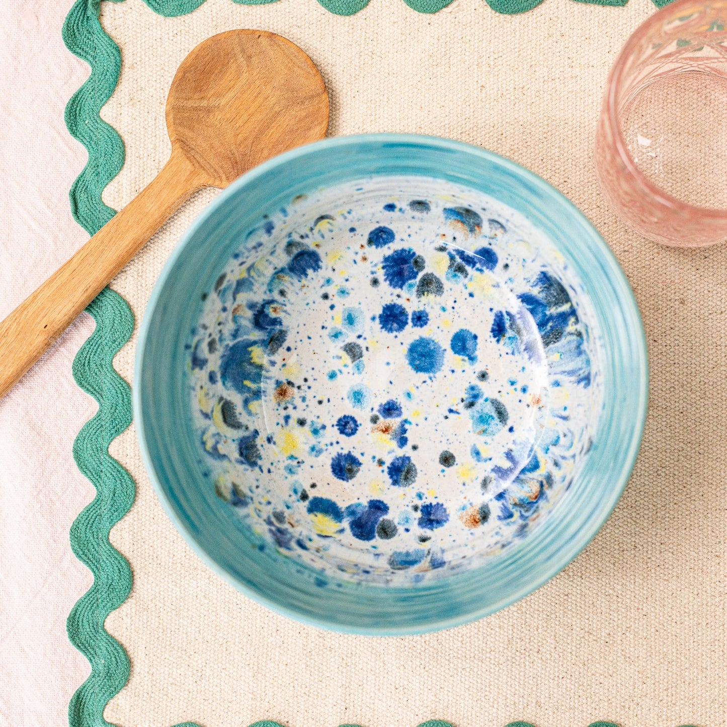 Ella Fletcher Designs Handmade Ramen Bowl in Blue Shoreline on a table with a spoon for scale