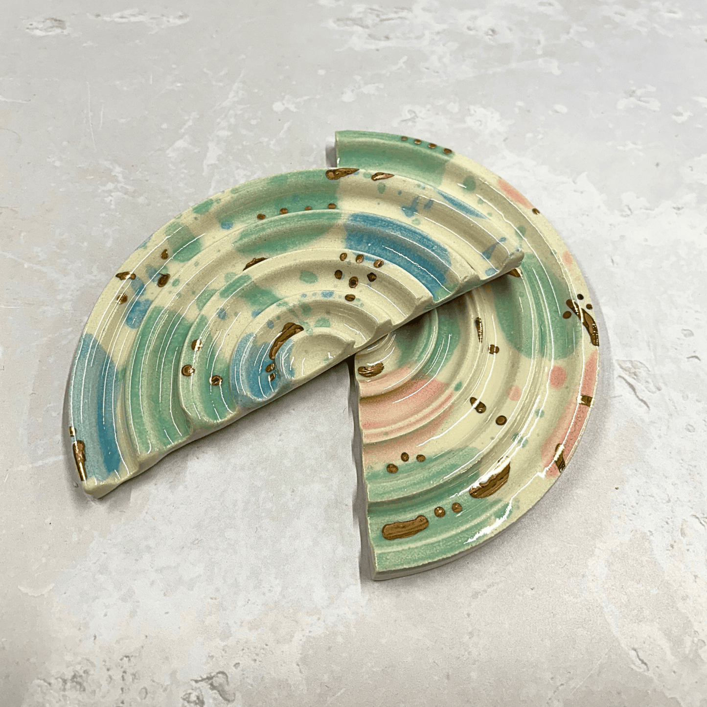 Ella Fletcher Designs Handmade Ceramics soap dish in Sea Glass design, semi-circle dish with ridges and splotches of pink, blue and green with gold