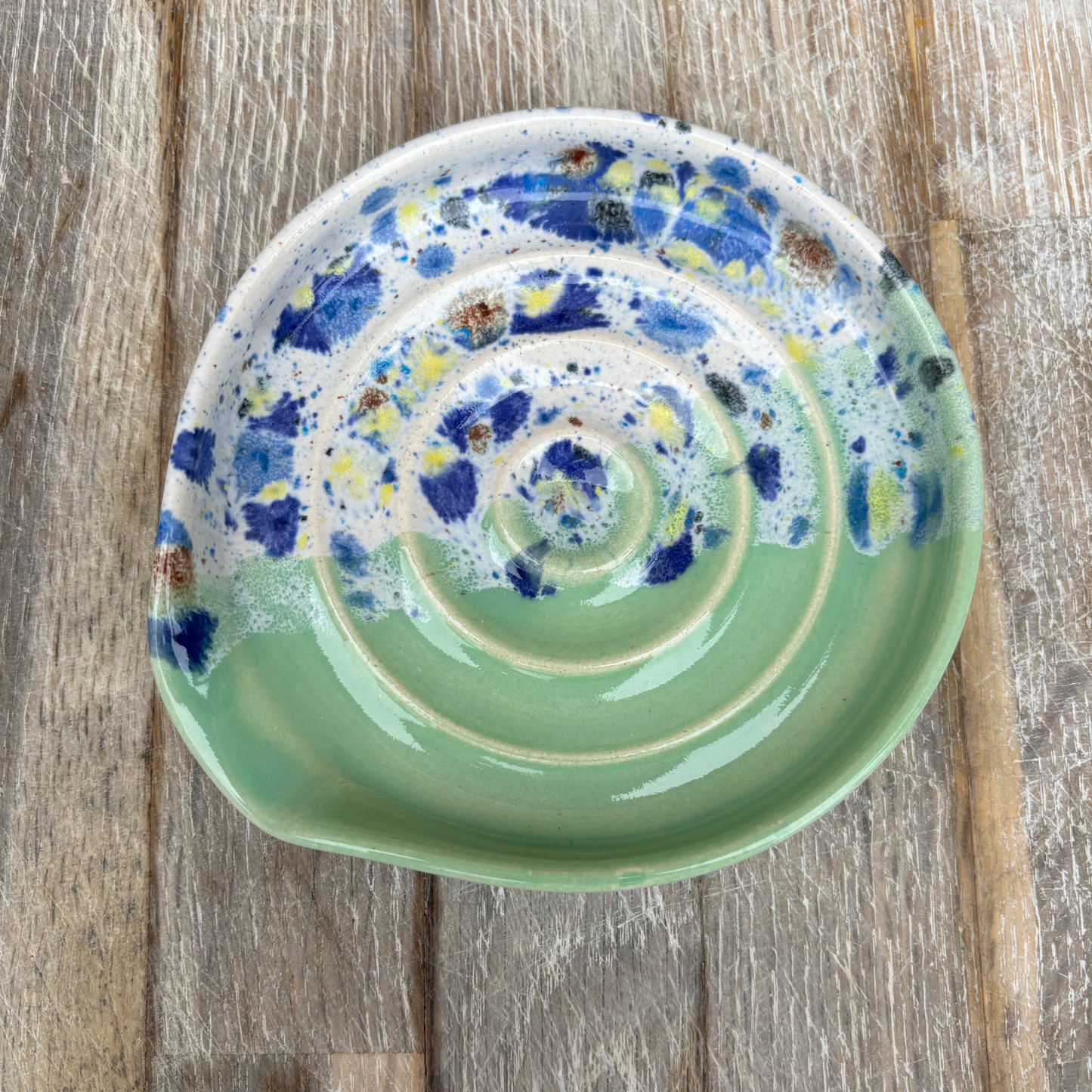 Ceramic plate with spiral design on a wooden surface