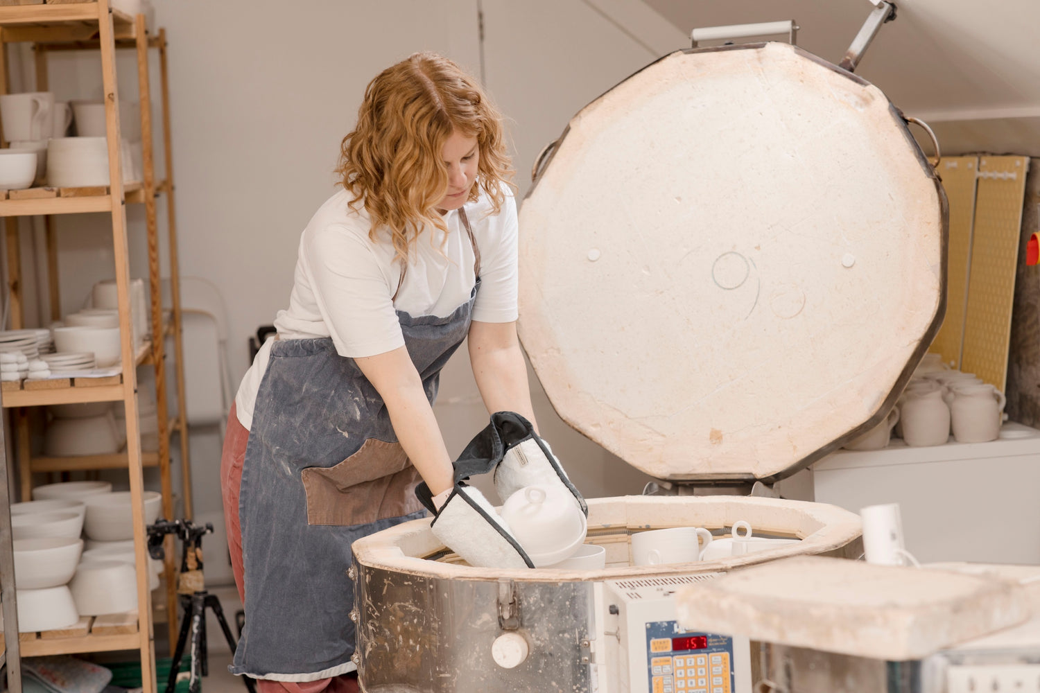 Ella Fletcher Designs Handmade Ceramic potter unloading the kiln