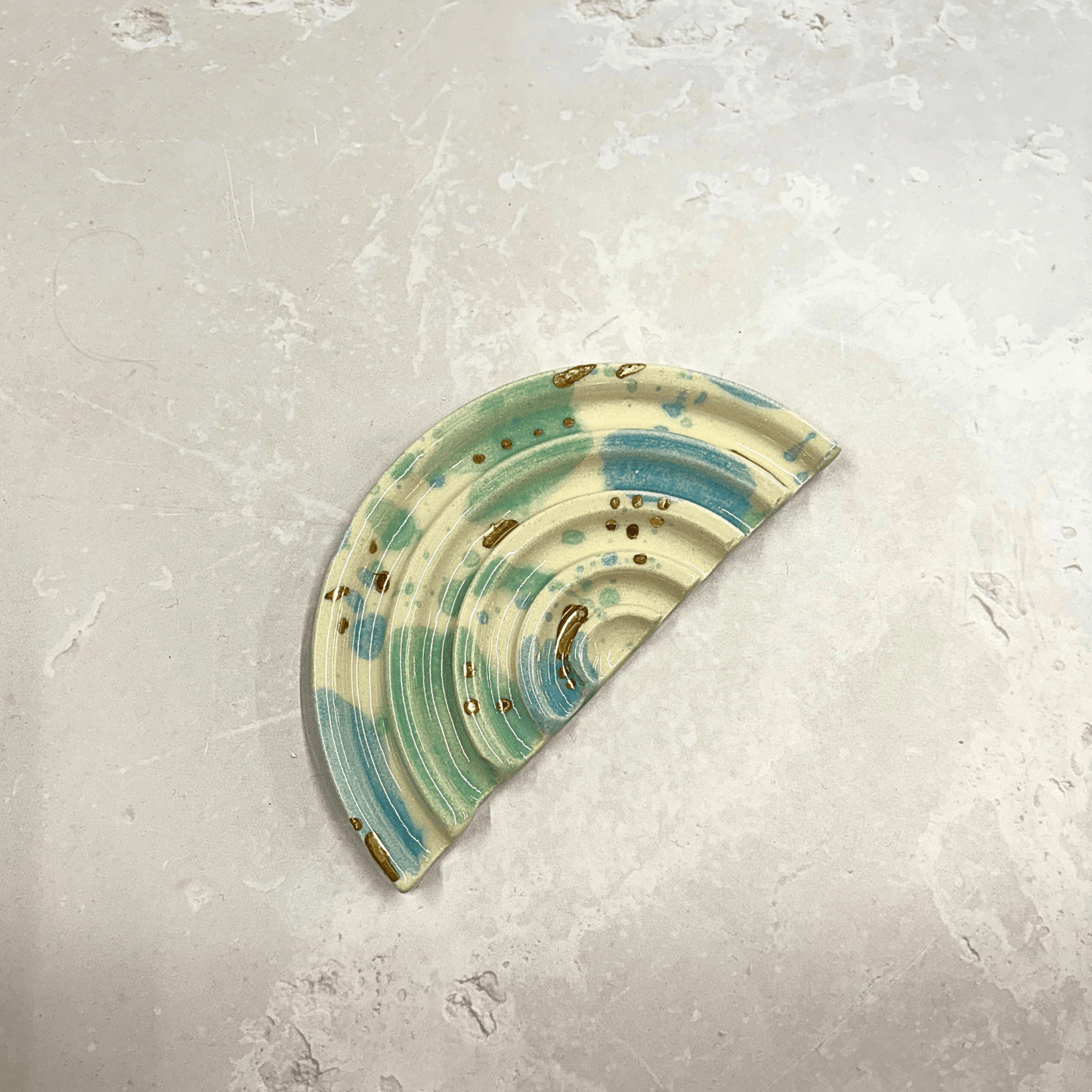 Ella Fletcher Designs Handmade Ceramics soap dish in Sea Glass design, semi-circle dish with ridges and splotches of blue and green with gold