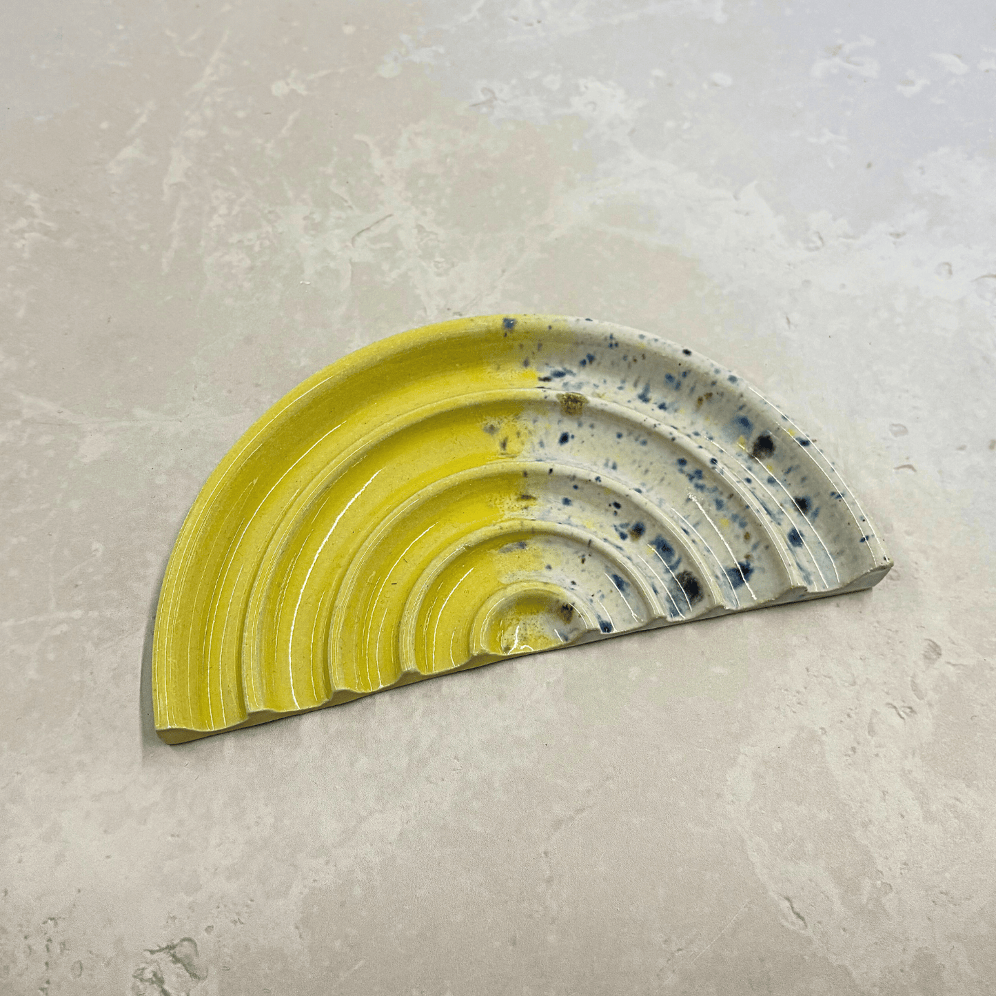 Ella Fletcher Designs Handmade UK Ceramic Soap Dish in Yellow Shoreline design, semi-circle with grooved edges, half yellow and half multi-coloured speckles
