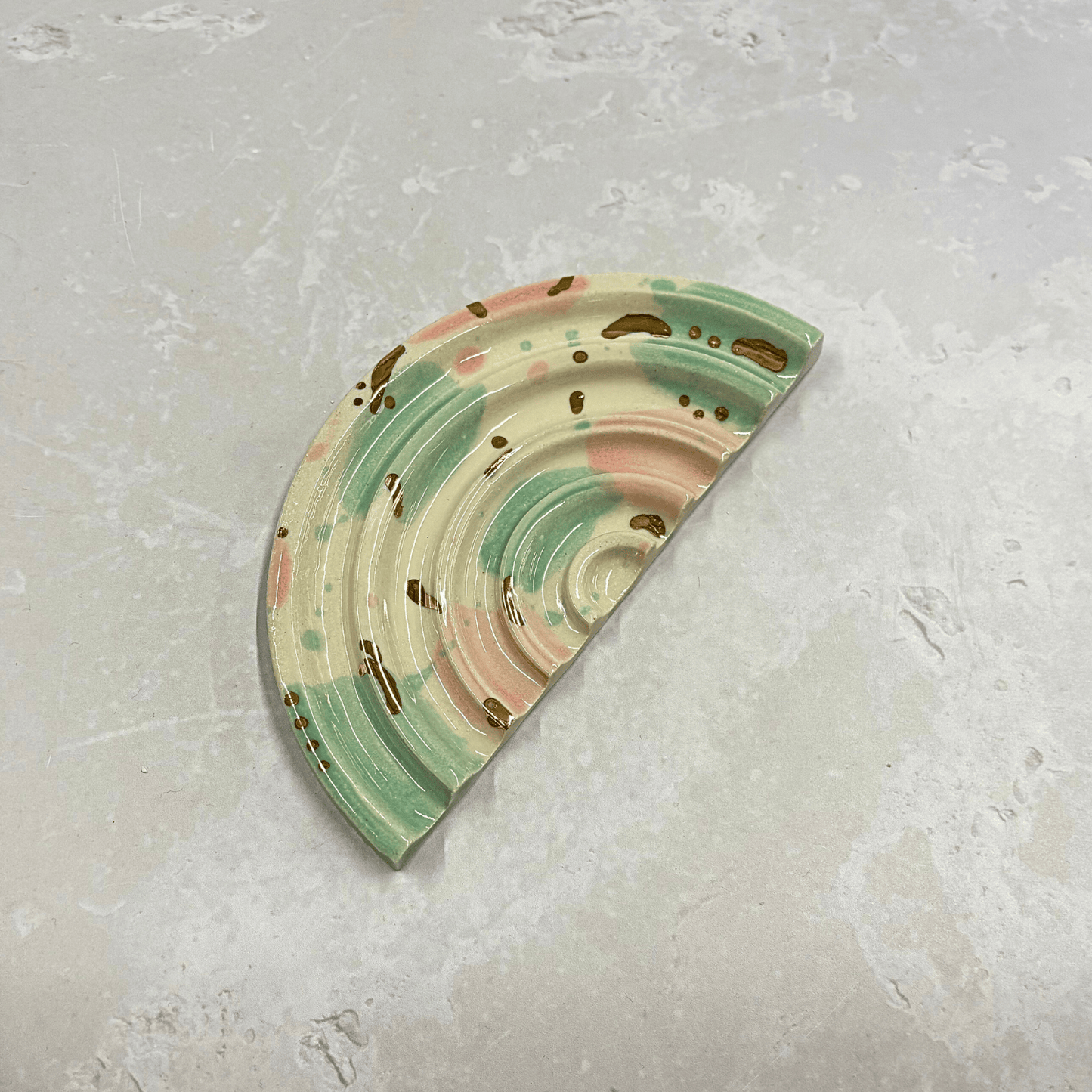 Ella Fletcher Designs Handmade Ceramics soap dish in Sea Glass design, semi-circle dish with ridges and splotches of pink and green with gold