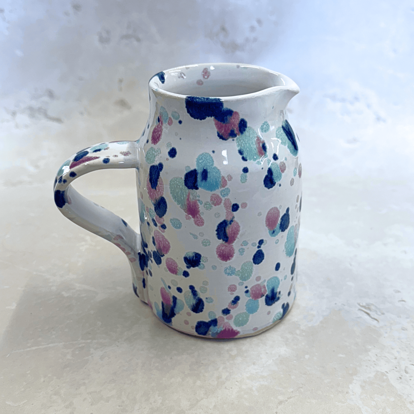 Ella Fletcher Designs Handmade Ceramic Jug in Sweetpea, white background with splatters of pinks, blues and greens