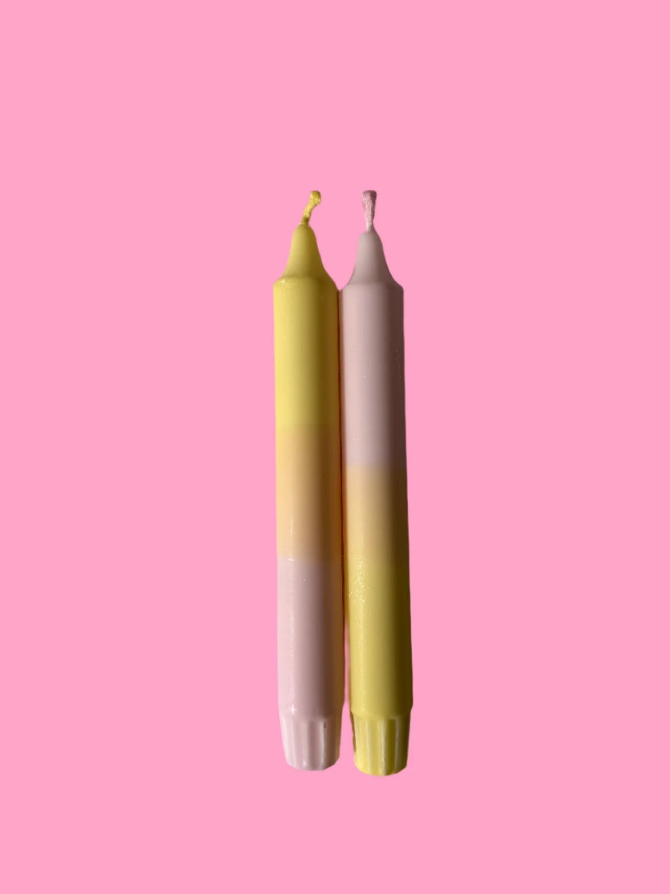 Tyninghame candles - two candle sticks with a pink background