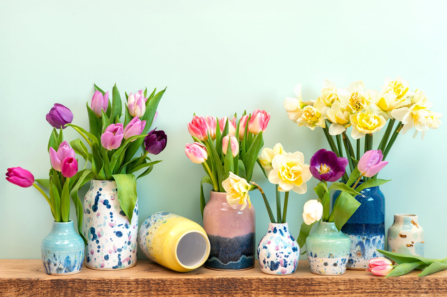 Colourful flowers to represent Handmade ceramic pieces by Ella Fletcher Designs displayed in a studio setting, showcasing colourful glazes inspired by Scottish landscapes