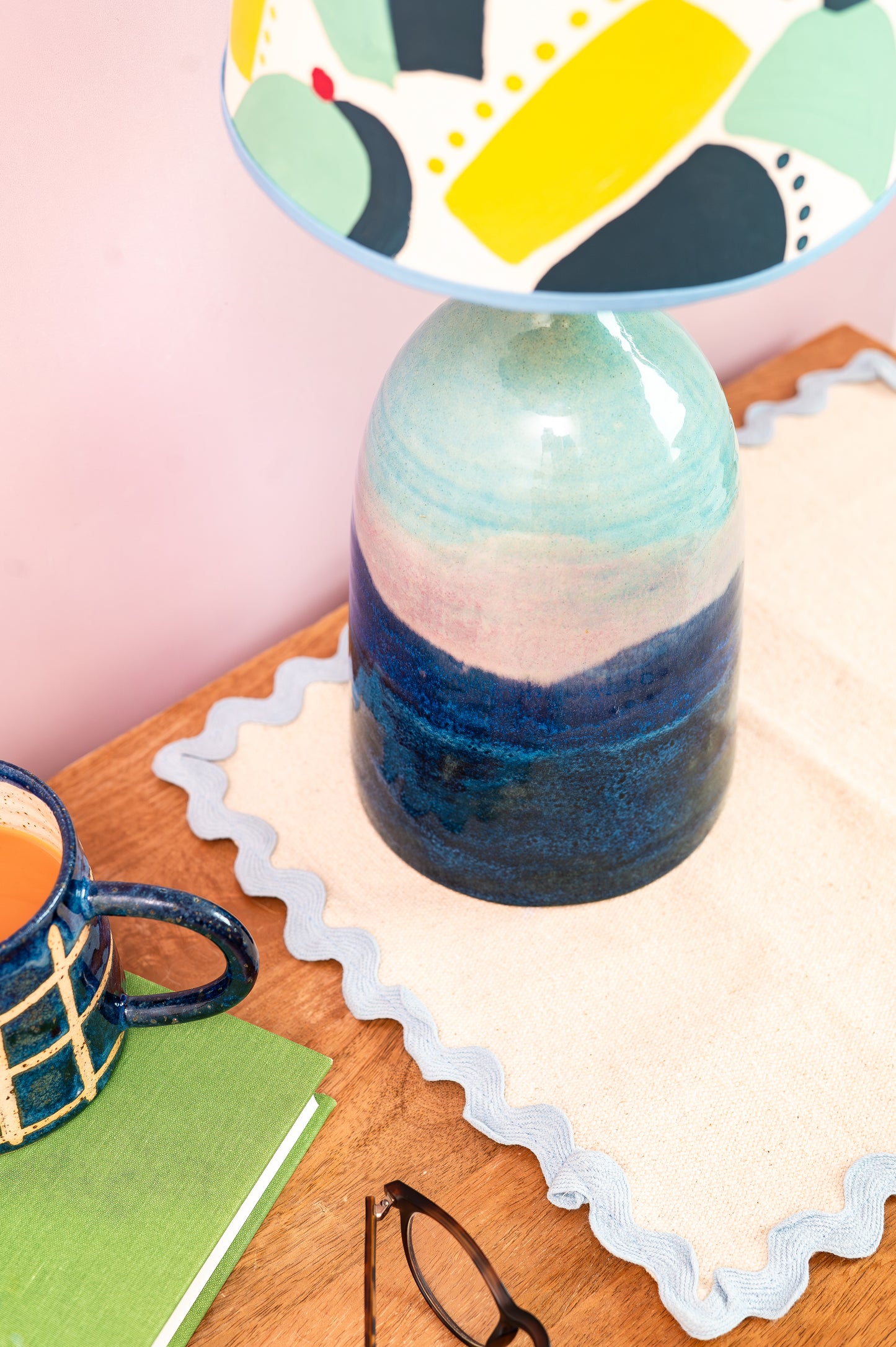 Ceramic vase with multicolored design on a wooden surface