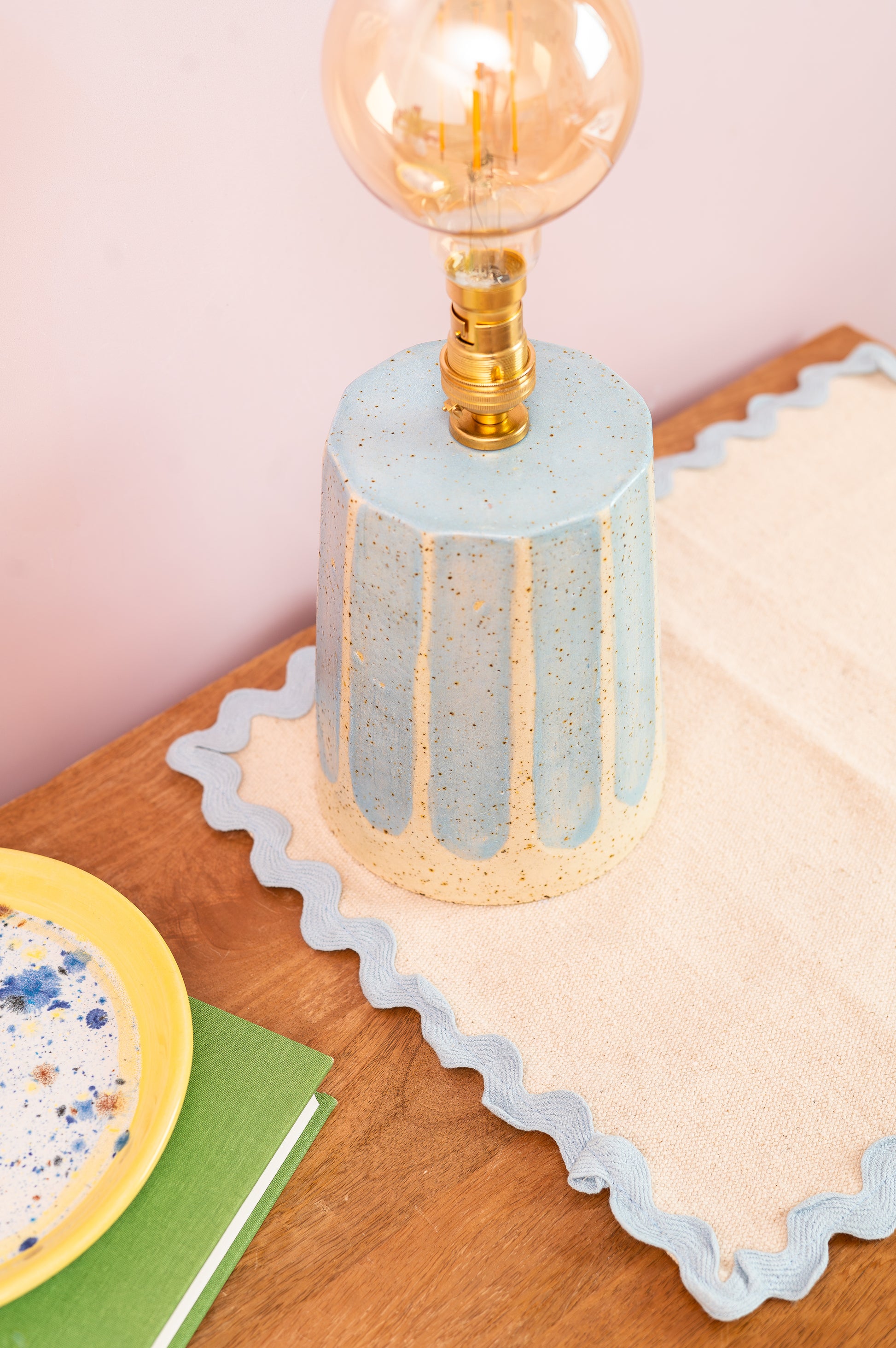 Decorative lamp with textured base on a wooden surface