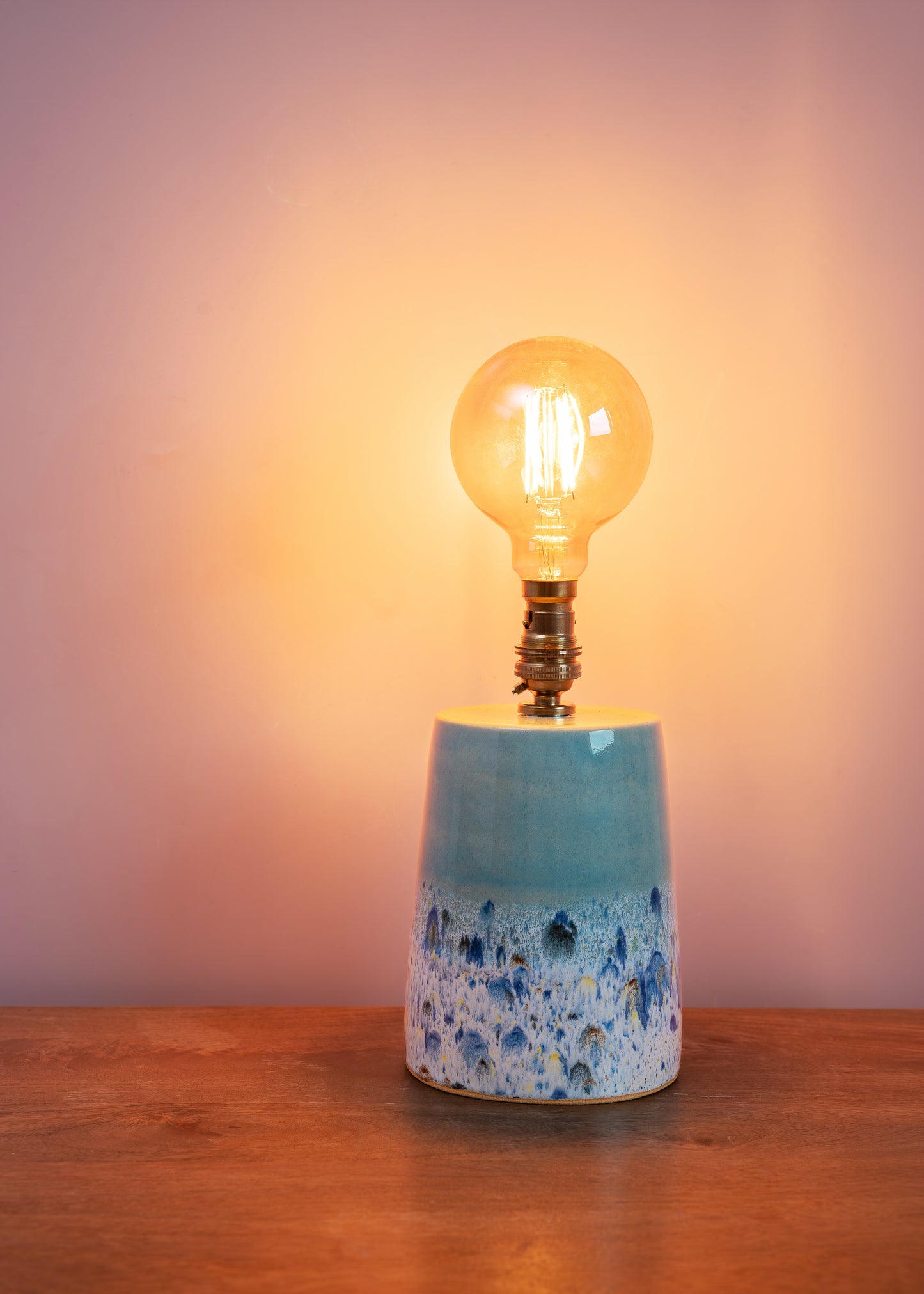 Light bulb on a ceramic base with a gradient background