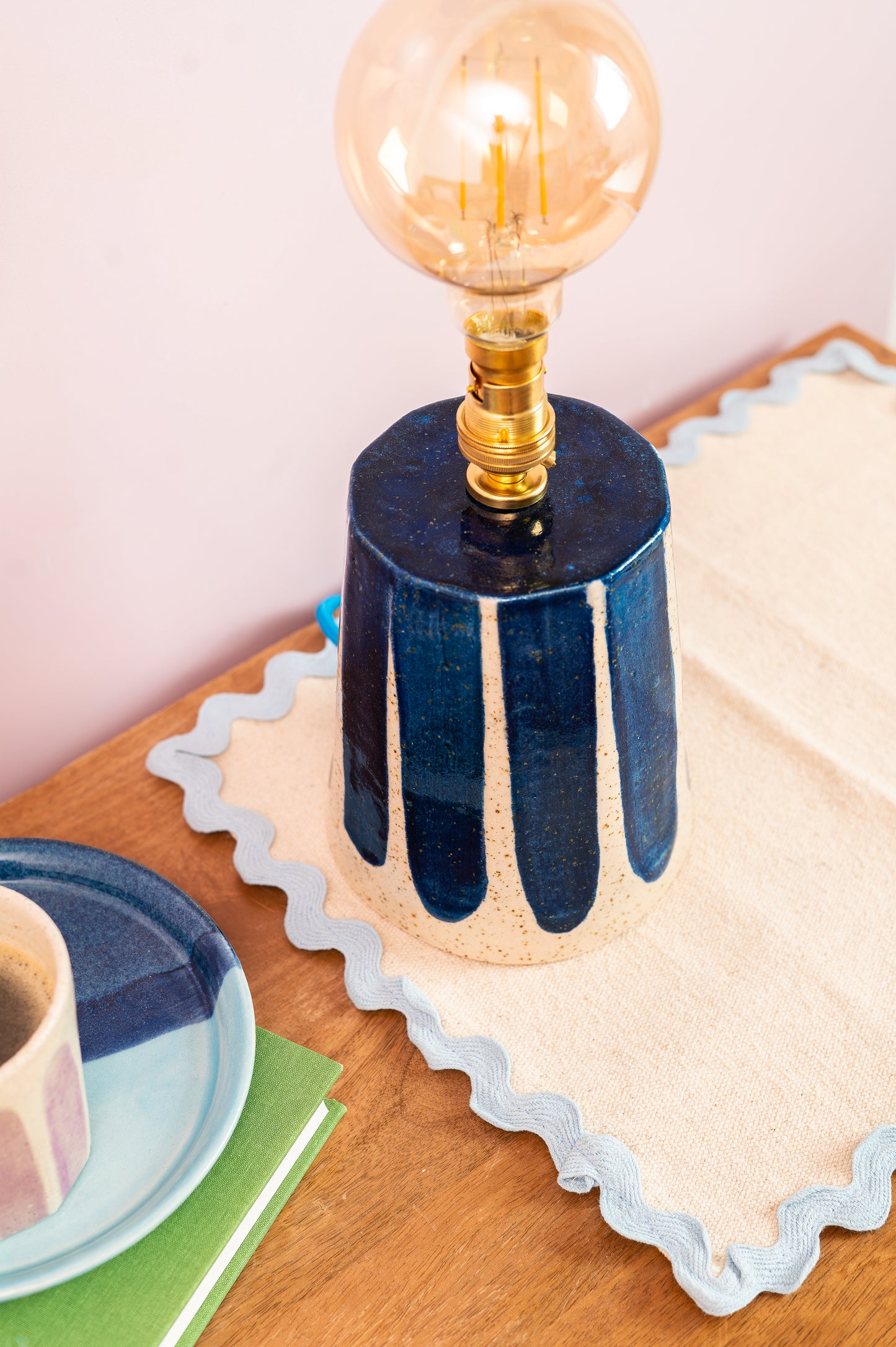 Small lamp with a decorative base on a wooden surface