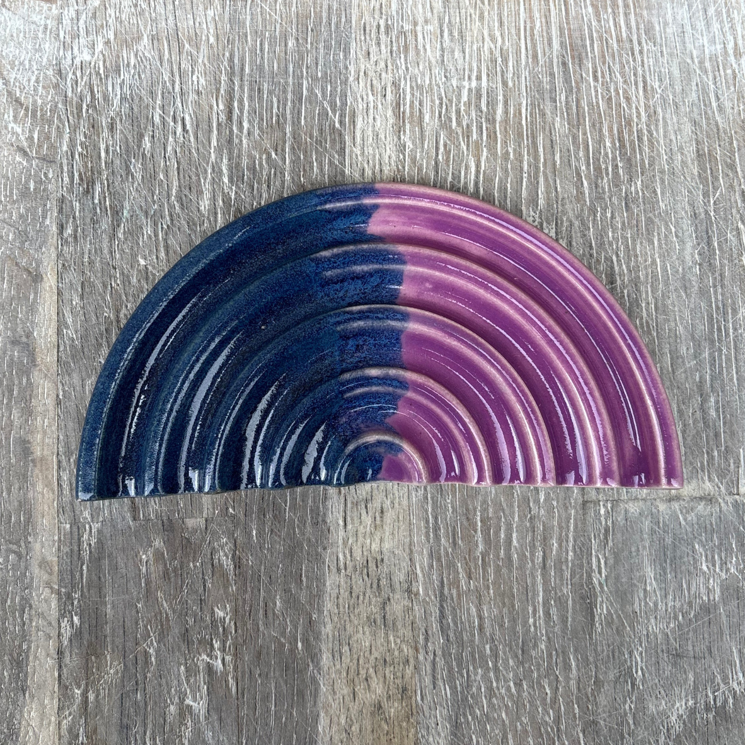 Half-circle soap dish with blue and purple gradient on a wooden surface