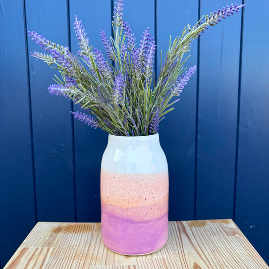 Vase with lavender against a blue wooden background