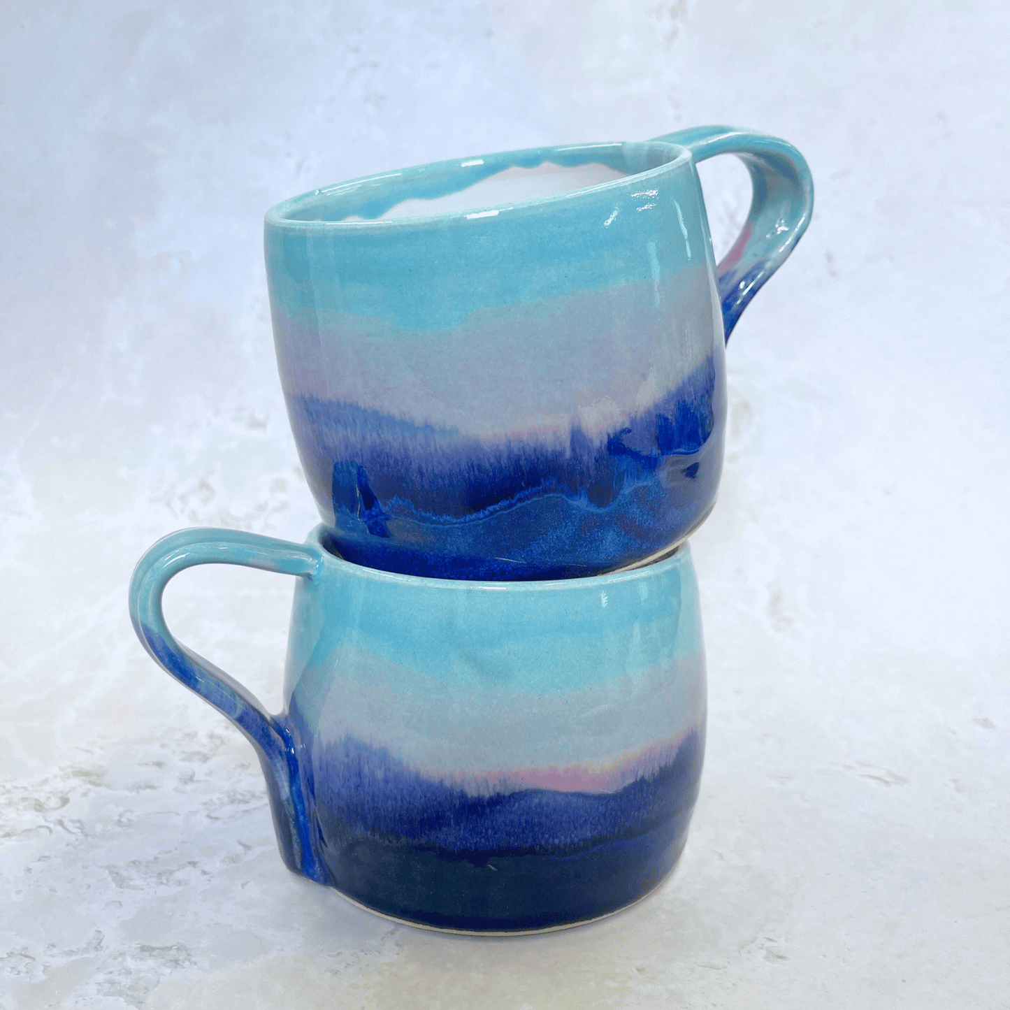Ella Fletcher Designs Handmade Ceramic Large Round Mugs in Scottish Sunrise Landscape Design, layers of blues and pinks inspired by the Scottish Sunrise and landscape