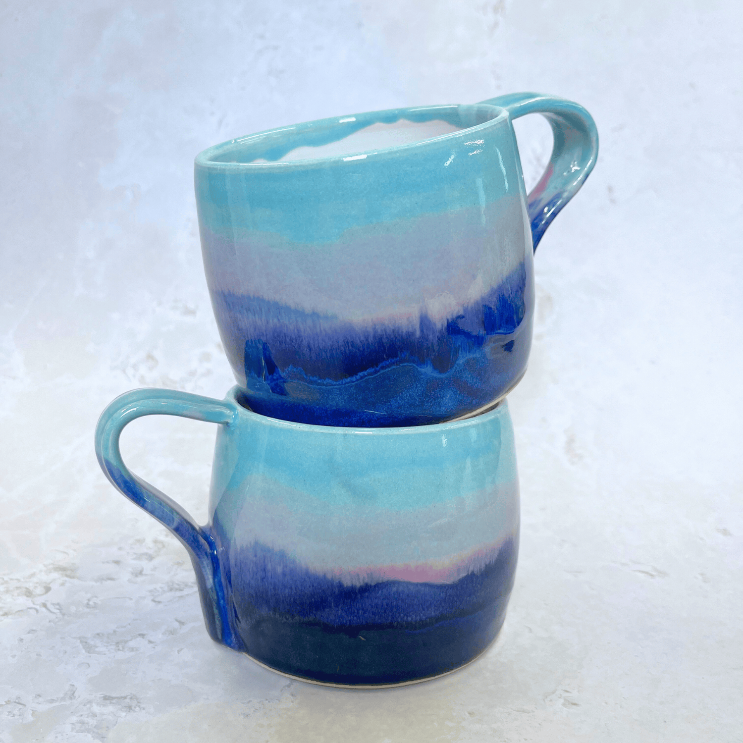 Ella Fletcher Designs Handmade Ceramic Large Round Mugs in Scottish Sunrise Landscape Design, layers of blues and pinks inspired by the Scottish Sunrise and landscape