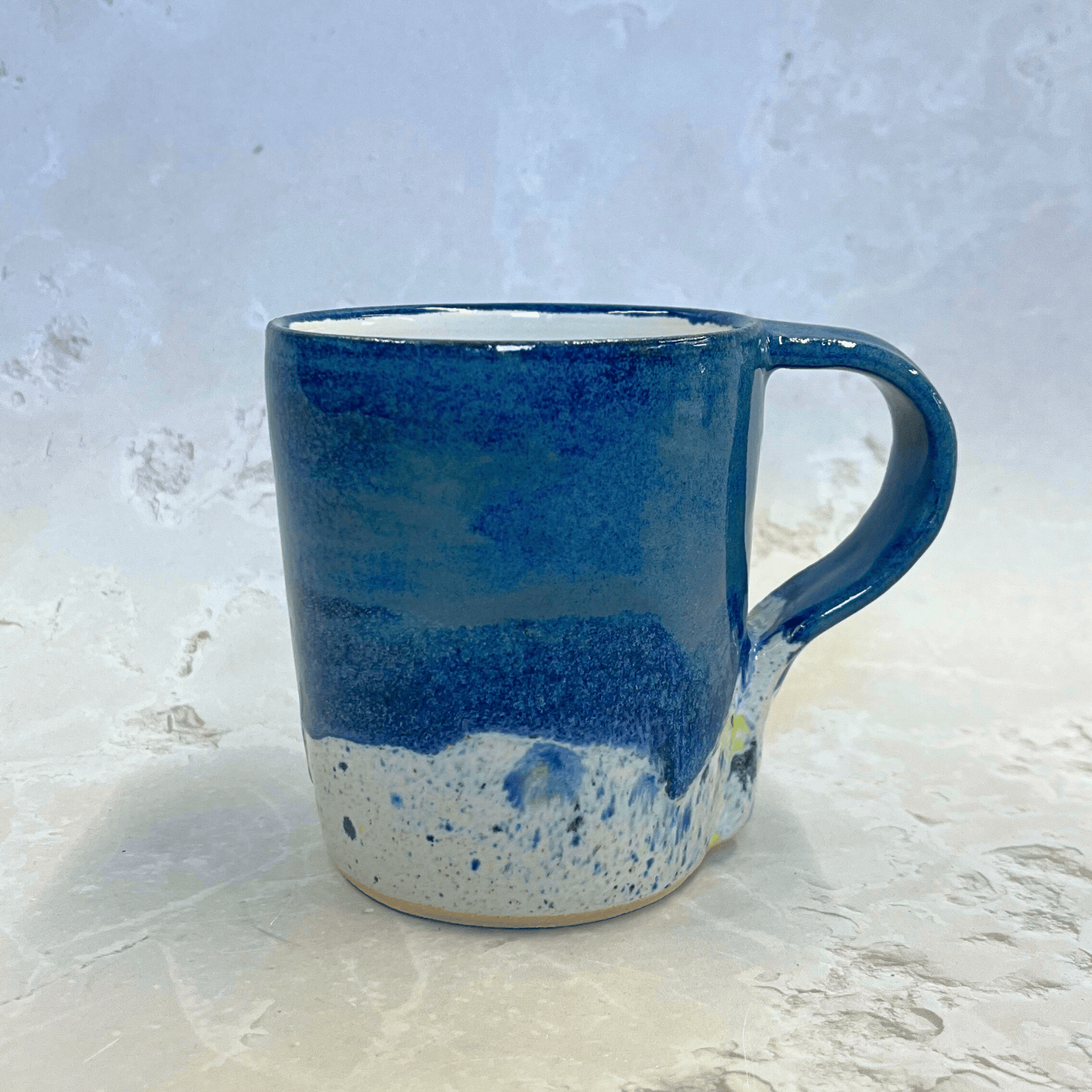 Ella Fletcher Designs Ceramic Pottery Mug in Navy Shoreline Design, Navy top half of mug with speckled bottom inspired by the shoreline of East Lothian beaches