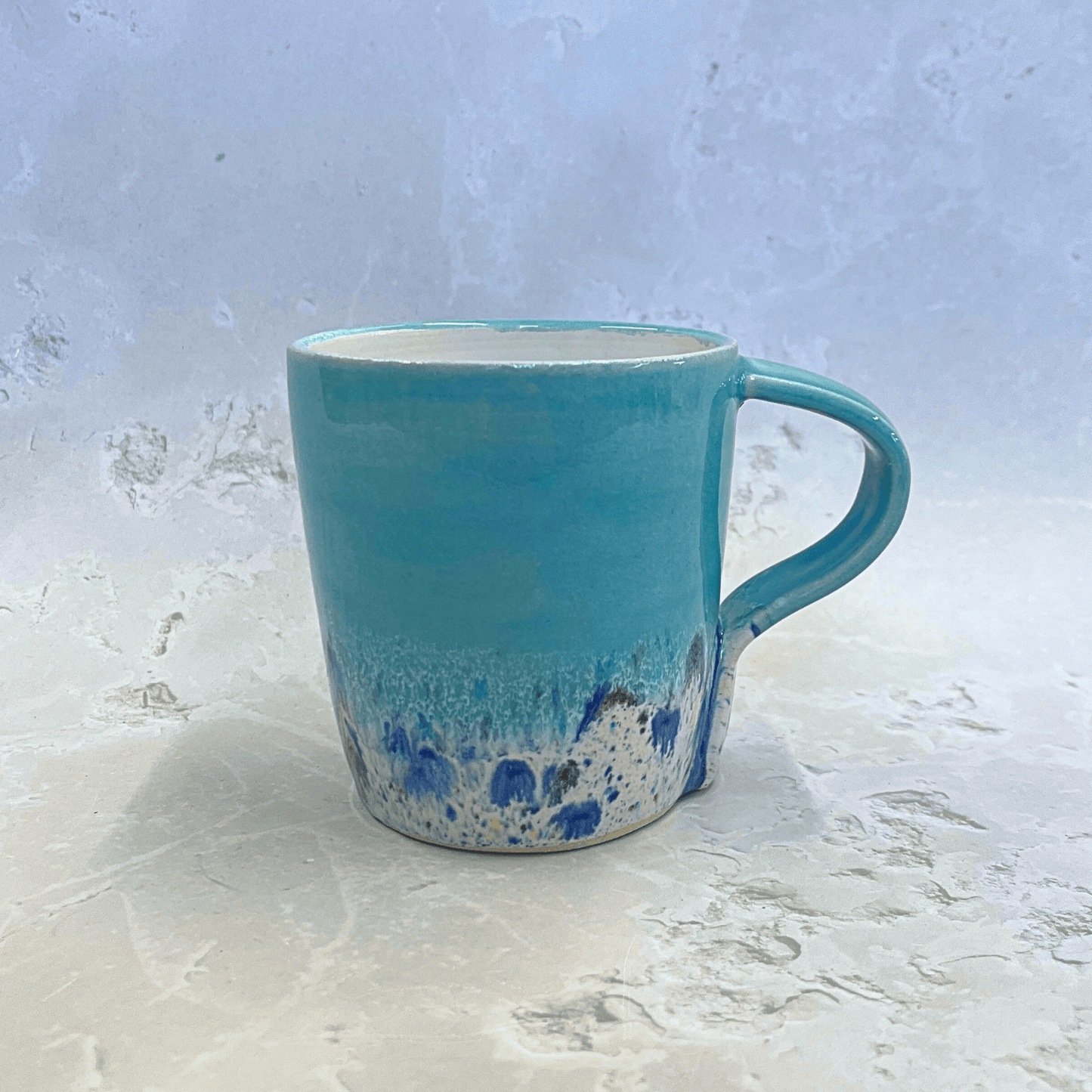 Ella Fletcher Designs Ceramic Standard Mug in Pale Blue Shoreline Design, pale blue top half with speckled bottom half inspired by the shoreline at East Lothian beaches
