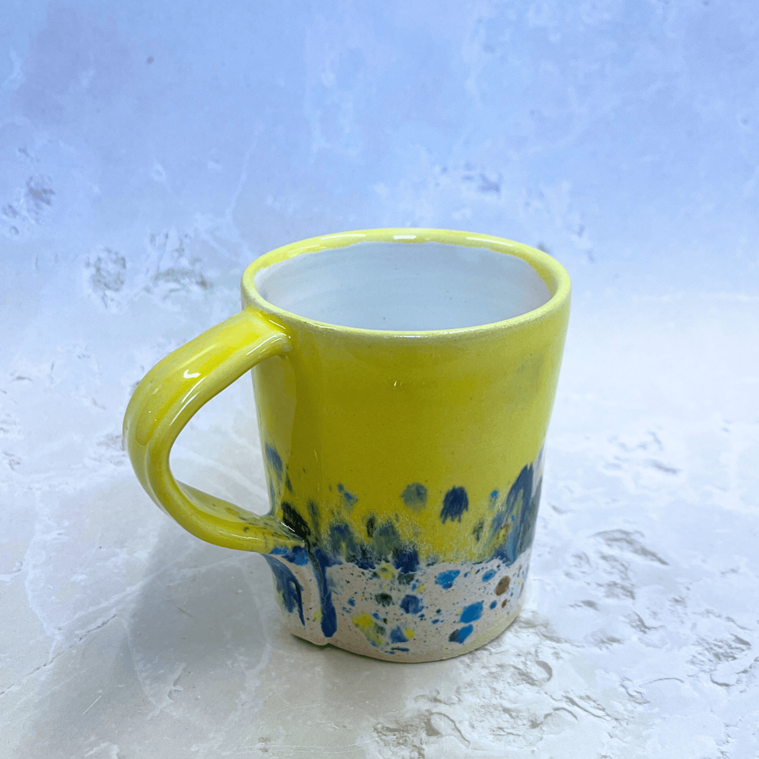 Ella Fletcher Designs Handmade Ceramic Mug in Yellow Shoreline Design, yellow top half with speckled bottom half inspired by the shoreline of East Lothian beaches