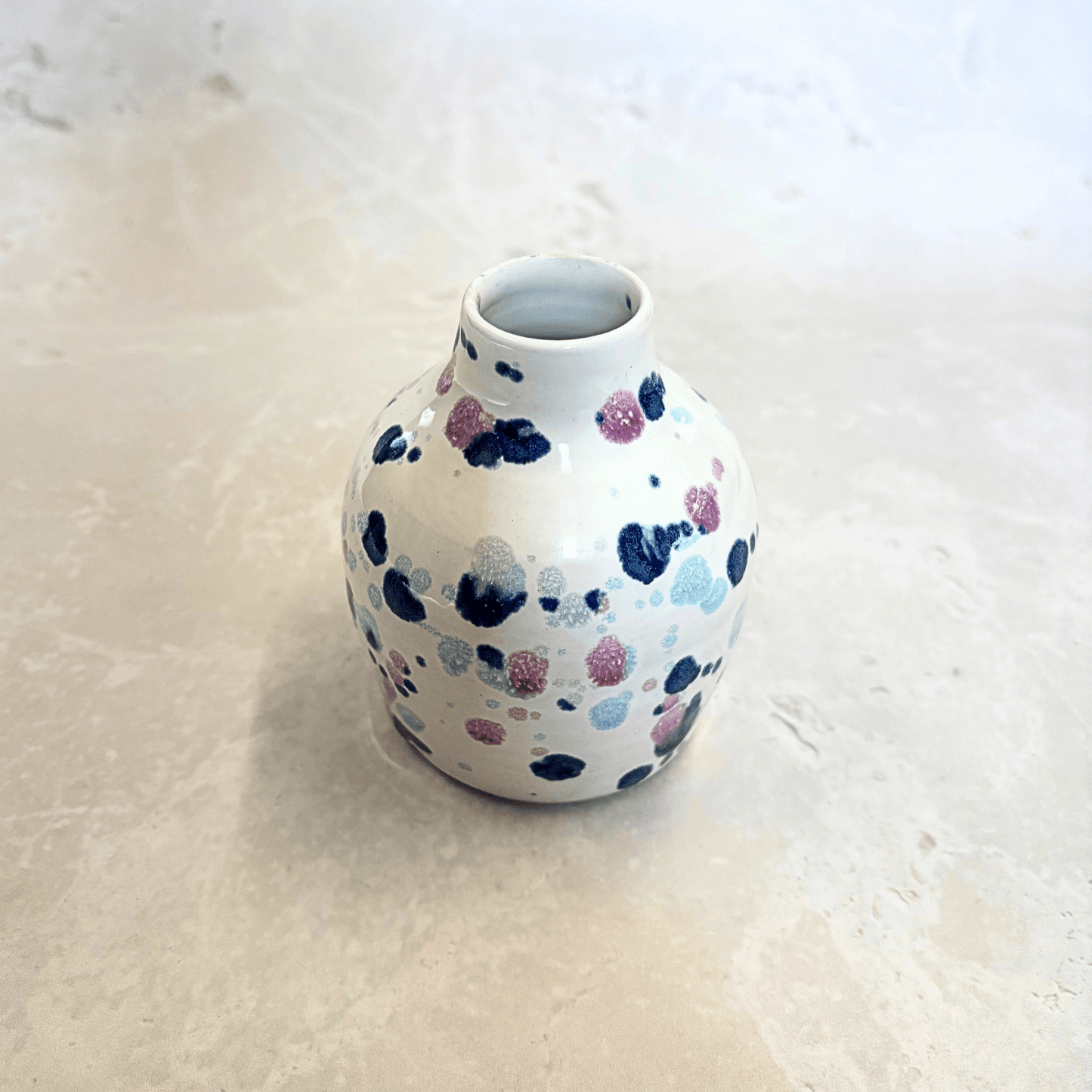 Ella Fletcher Designs Handmade Ceramics bud vase in Sweetpea design, small vase with white background and splatters of blues and pinks
