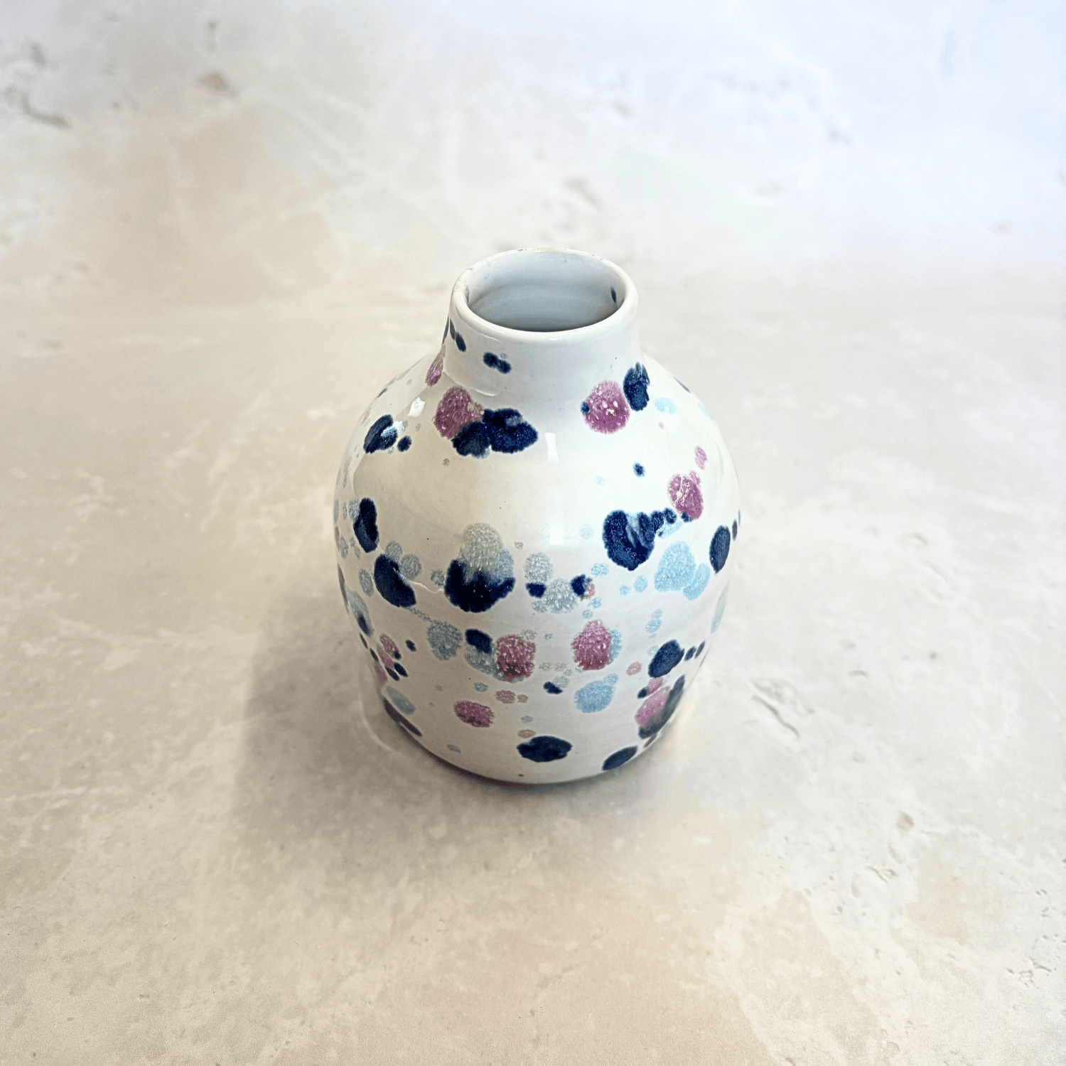 Ella Fletcher Designs Handmade Ceramics bud vase in Sweetpea design, small vase with white background and splatters of blues and pinks