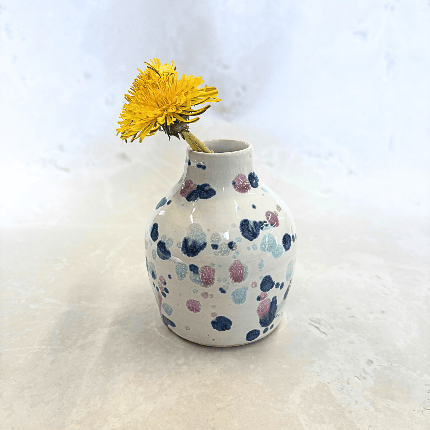 Ella Fletcher Designs Handmade Ceramics bud vase in Sweetpea design, small vase with white background and splatters of blues and pinks