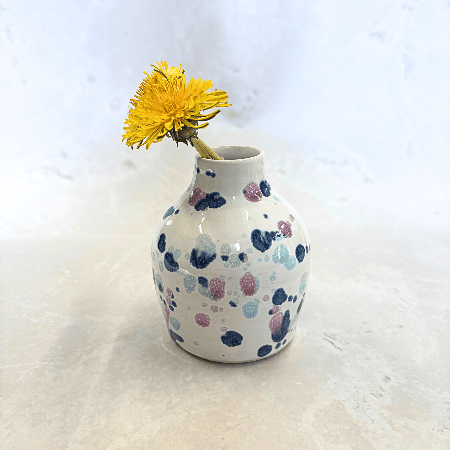 Ella Fletcher Designs Handmade Ceramics bud vase in Sweetpea design, small vase with white background and splatters of blues and pinks
