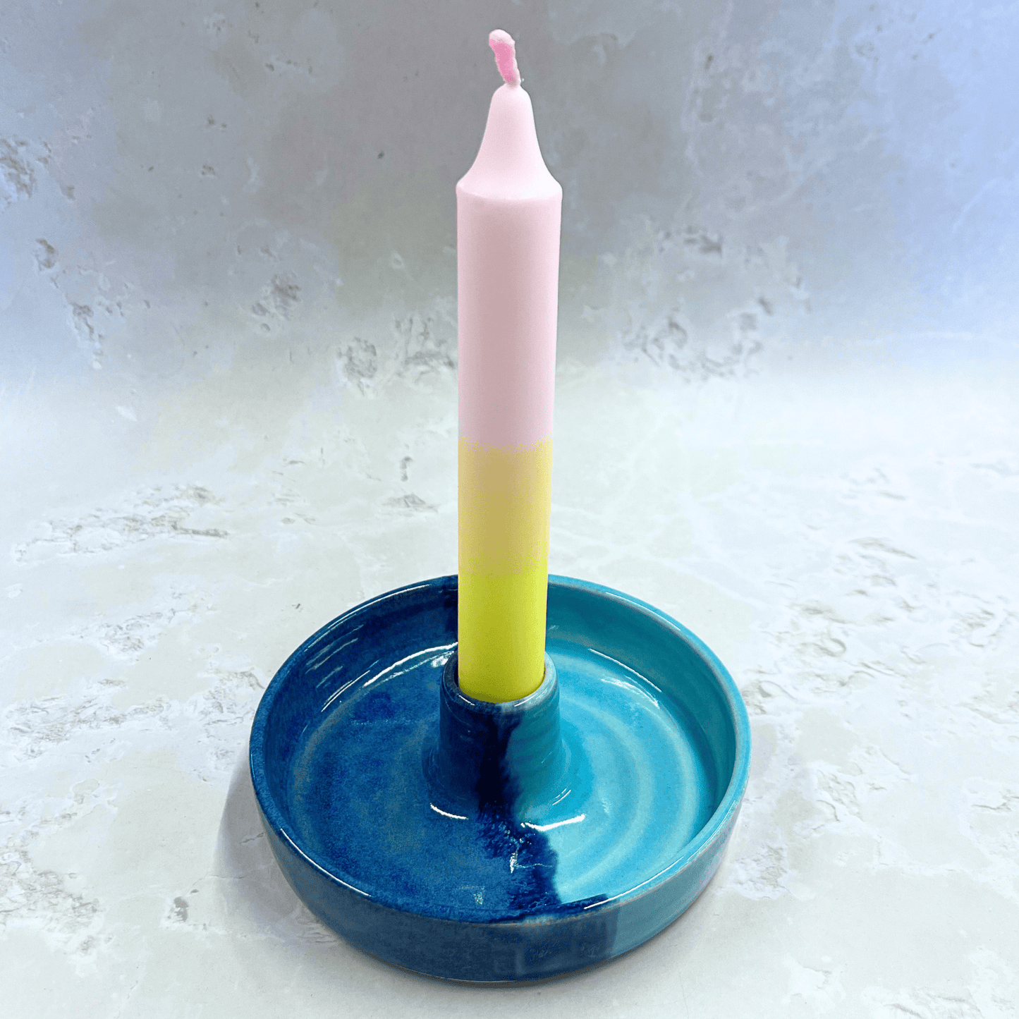 Ella Fletcher Designs Handmade Ceramic Candlestick holder in Blue Scottish Landscape design, circular candlestick holder with layered dark and light blues featuring a candle