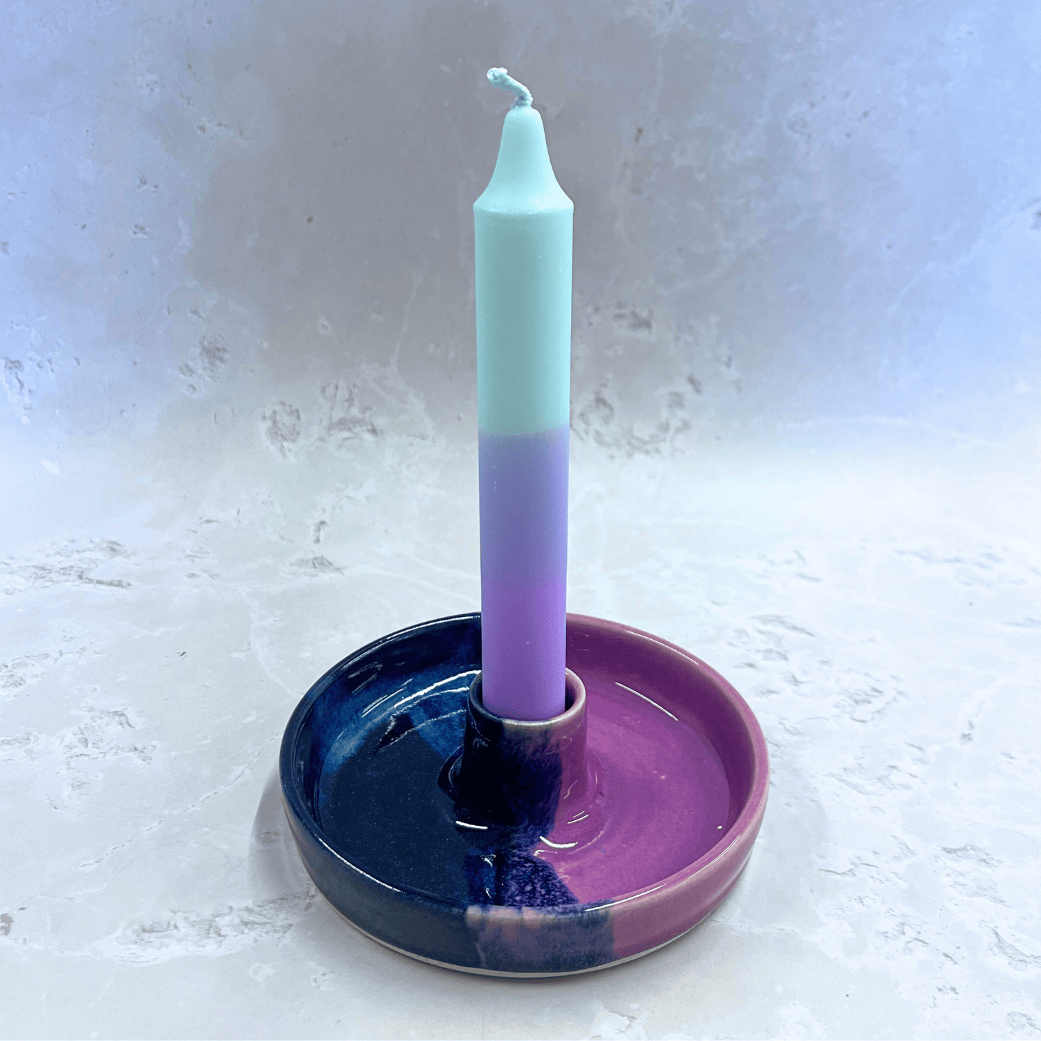 Ella Fletcher Designs Handmade Ceramics Candlestick holder in Blue Scottish Landscape design, circular candlestick holder with layered dark and light blues and pink with a candle