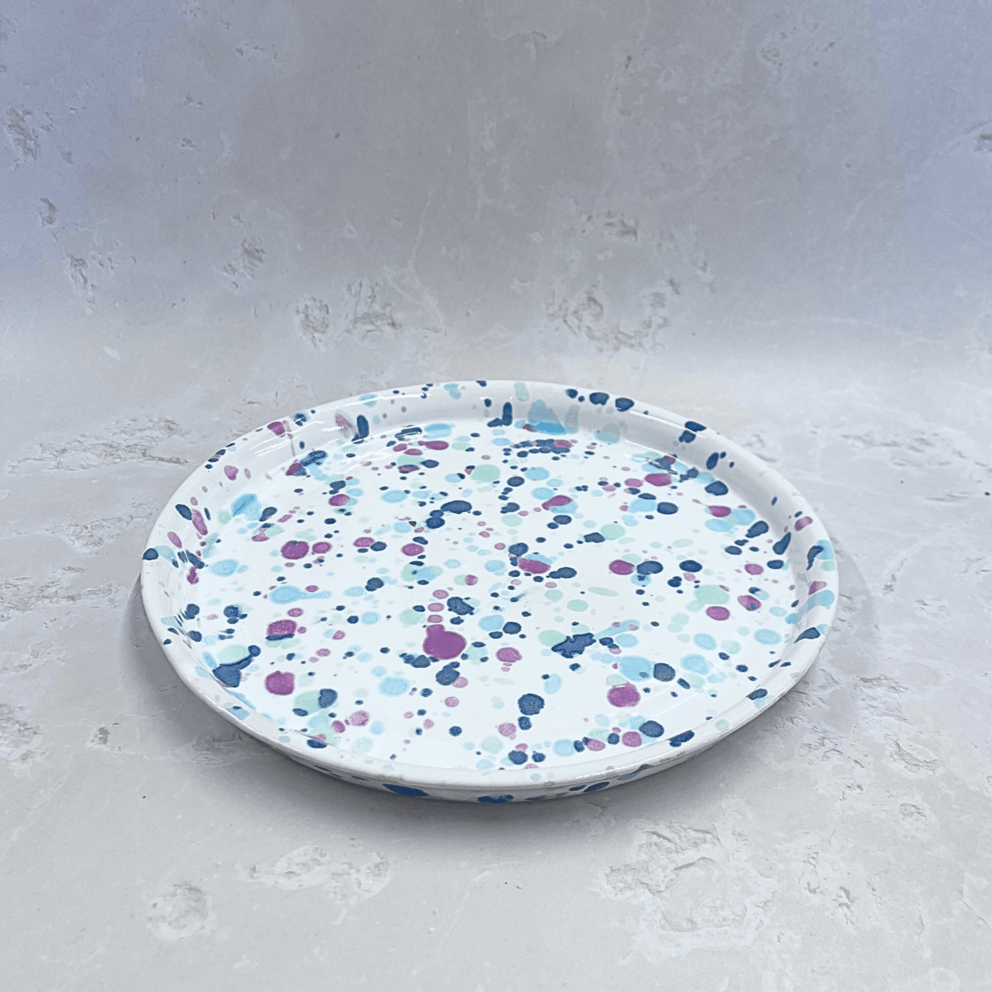 Ella Fletcher Designs Handmade Ceramic Dinner Plate in Sweetpea, circular plate with white background speckled with pinks and blues to resemble a sweet pea flower