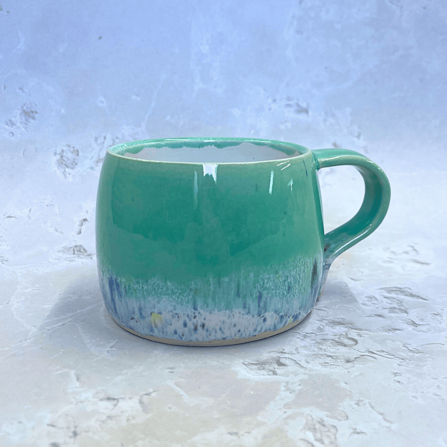Ella Fletcher Designs Handmade Pottery Round Large Mug in Pale Green Shoreline with green and multi-coloured speckled design inspired by the Scottish shoreline