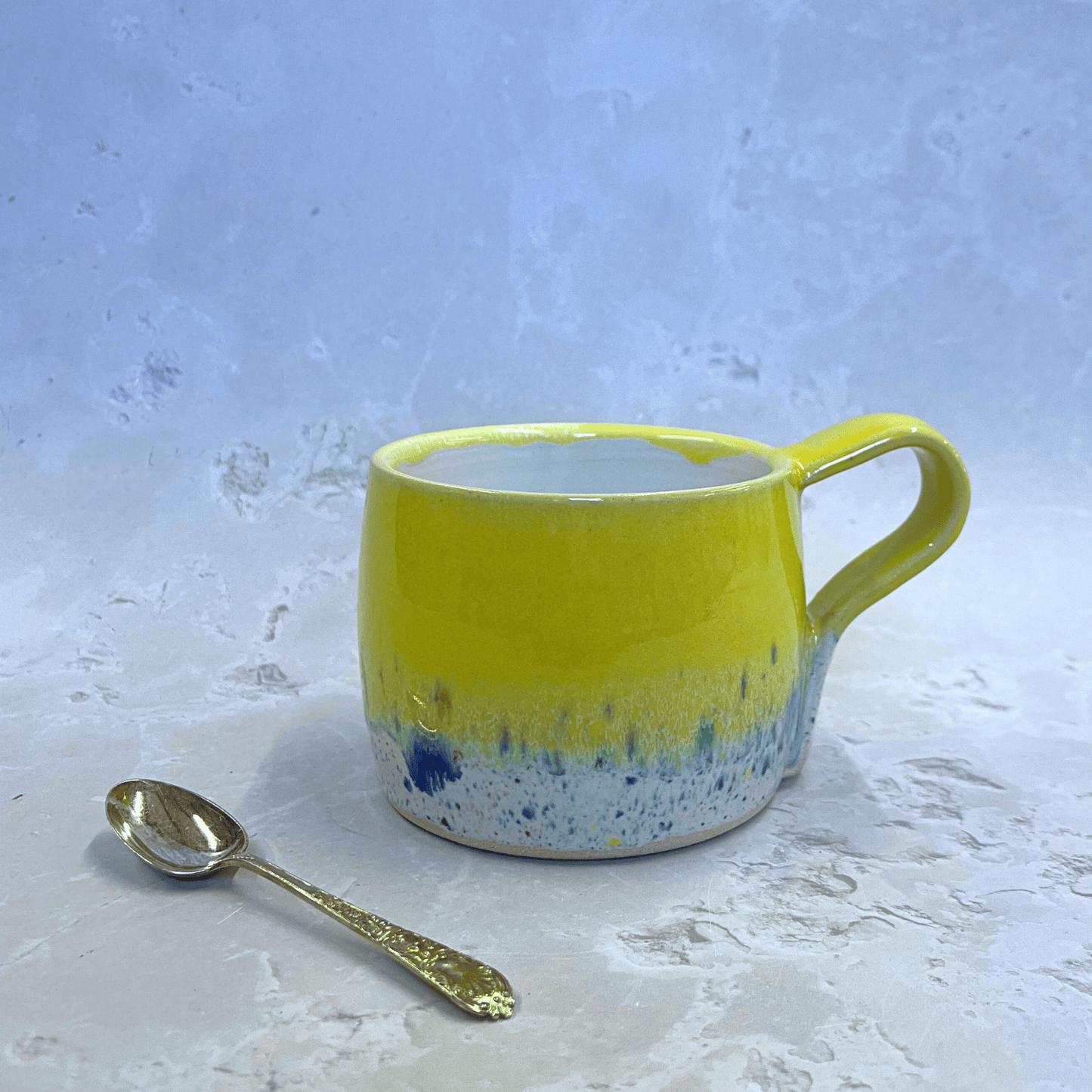 Ella Fletcher Designs Handmade Pottery Round Large Mug in yellow Shoreline, ceramic mug in yellow and multi-coloured speckled design inspired by the Scottish shoreline