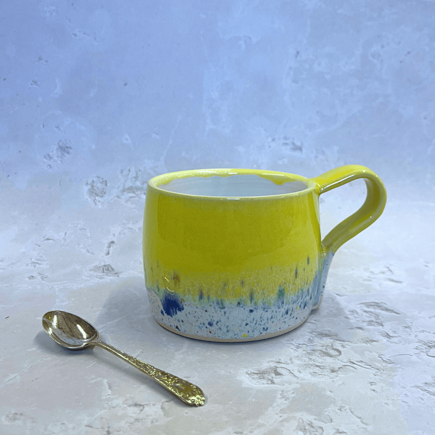 Ella Fletcher Designs Handmade Pottery Round Large Mug in yellow Shoreline, ceramic mug in yellow and multi-coloured speckled design inspired by the Scottish shoreline