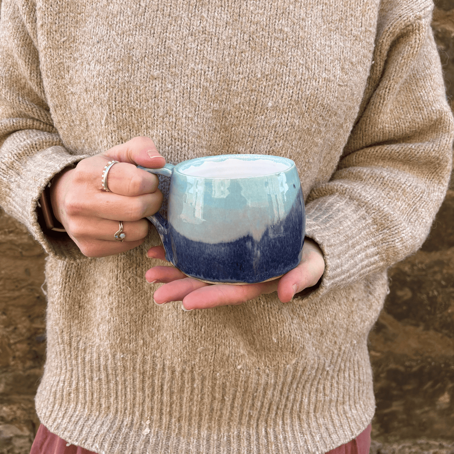 Ella Fletcher Designs Handmade Ceramic Large Round Mug in Scottish Sunrise Landscape design, large mug being held featuring layers of pinks and blues