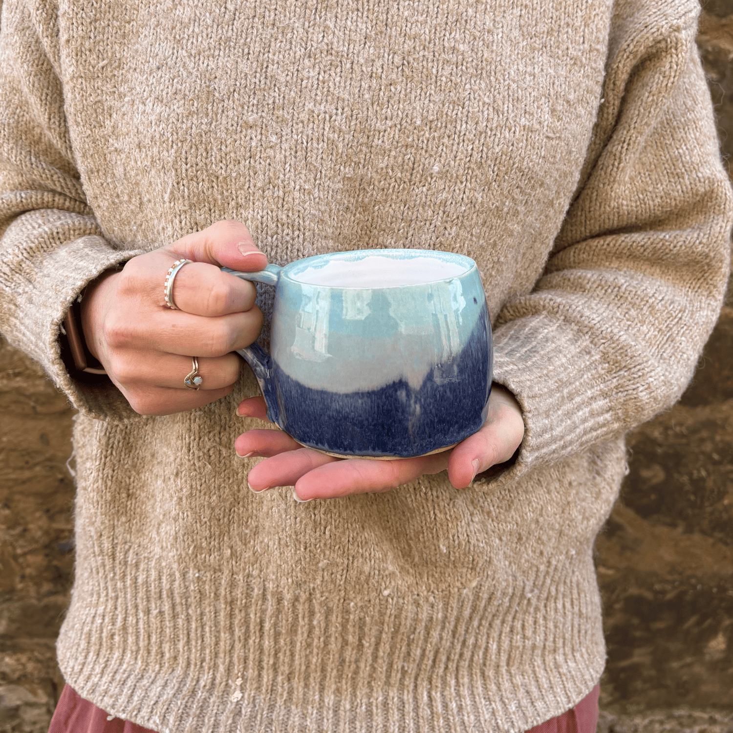 Ella Fletcher Designs Handmade Ceramic Large Round Mug in Scottish Sunrise Landscape design, large mug being held featuring layers of pinks and blues