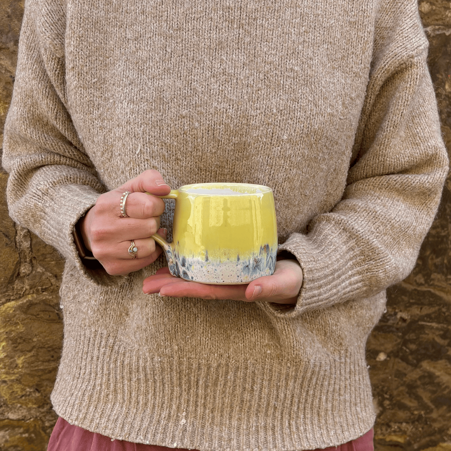 Ella Fletcher Designs Handmade Ceramic Mug in Yellow Shoreline Design, round mug held with yellow and multicolour speckle design