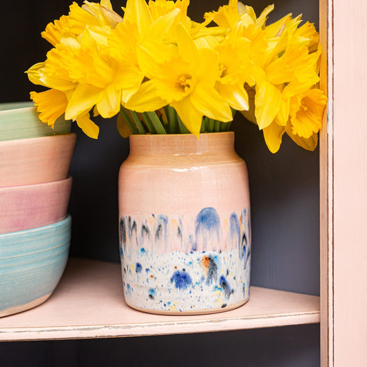 Ella Fletcher Designs Handmade Ceramic Medium Vase in Pink Shoreline design, pink and multicoloured speckled vase with yellow daffodils inside