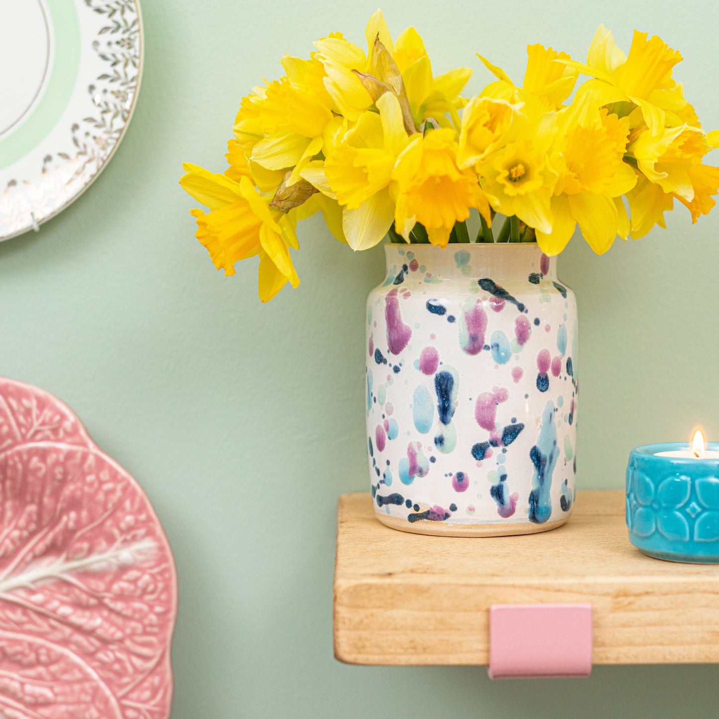 Ella Fletcher Designs Handmade Ceramic Medium Vase in Sweetpea, vase with white background and splattered pinks and blues featured with daffodils