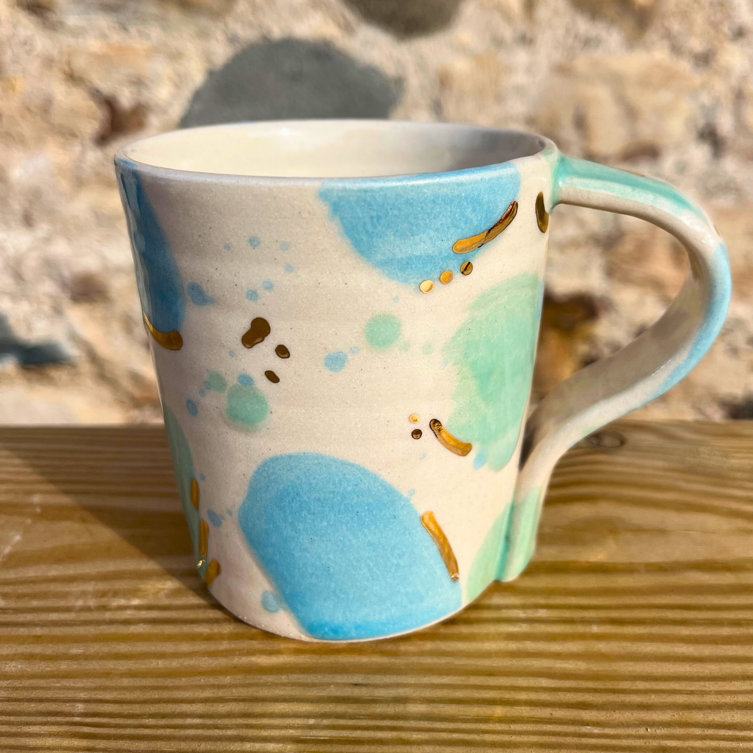 Colorful mug with abstract design on a wooden surface