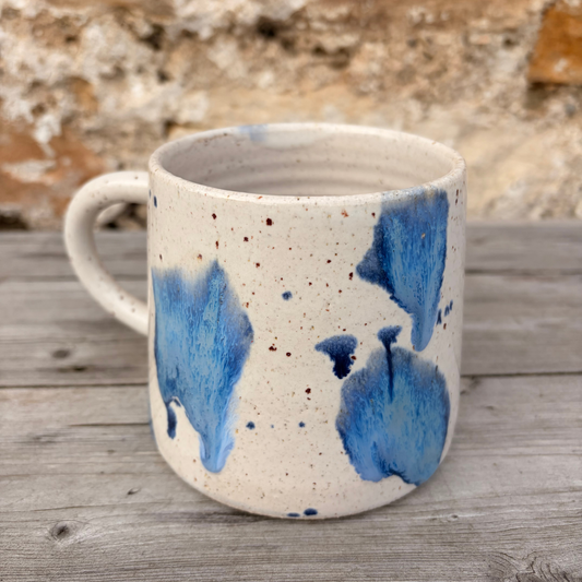 Ceramic mug with blue abstract patterns on a wooden surface