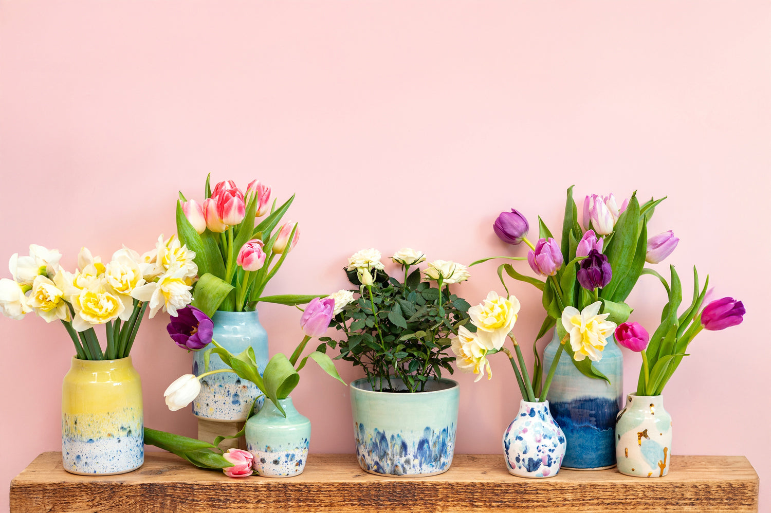 Ella Fletcher Designs Handmade Ceramic Display of Ella Fletcher Designs handmade ceramics from various collections, arranged on open shelves in a bright studio setting