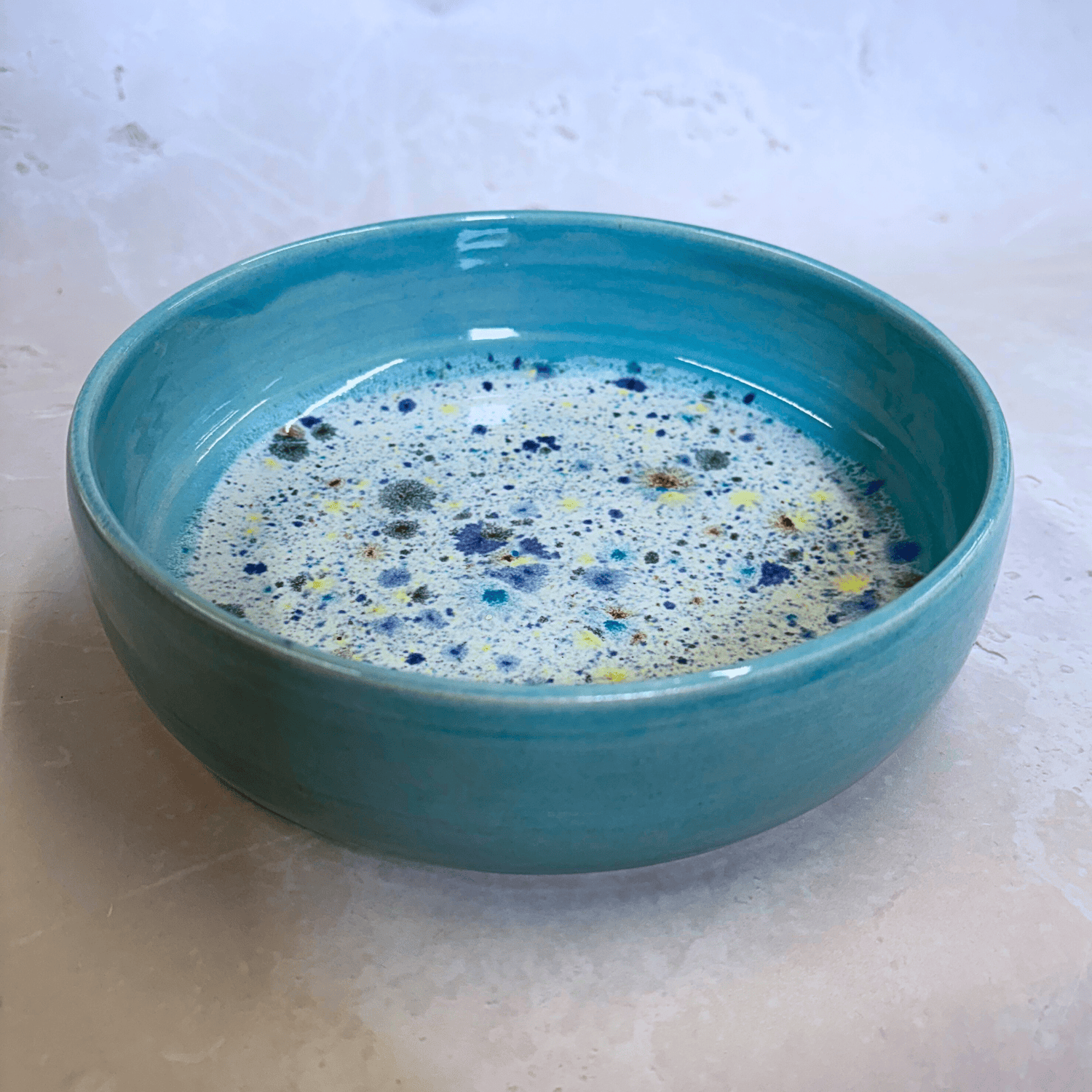 Ella Fletcher Designs Handmade Ceramics Pasta Bowl in Blue Shoreline, blue rimmed pasta bowl with multicoloured speckles inside