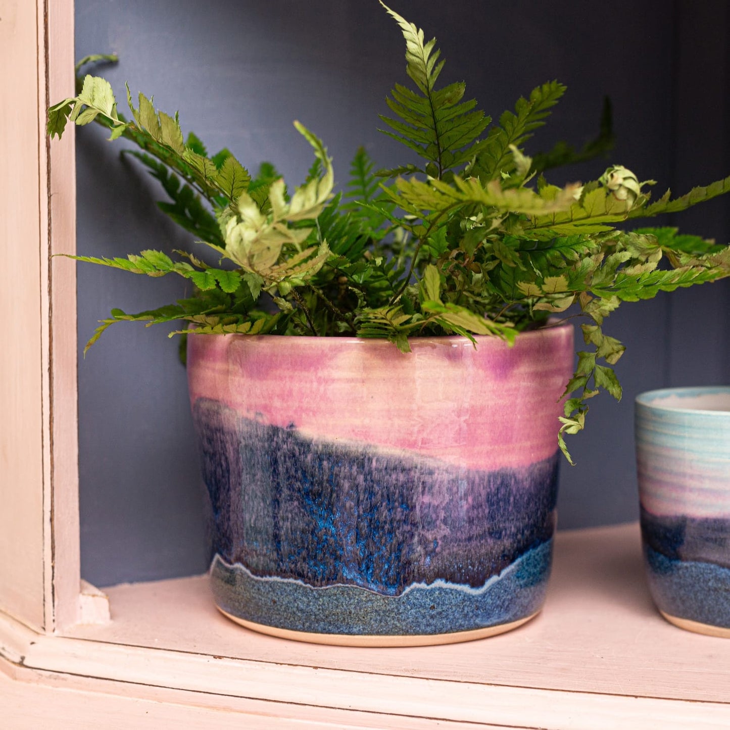 Ella Fletcher Designs Handmade Ceramic Pot in Landscape Design, featuring a plant on a shelf
