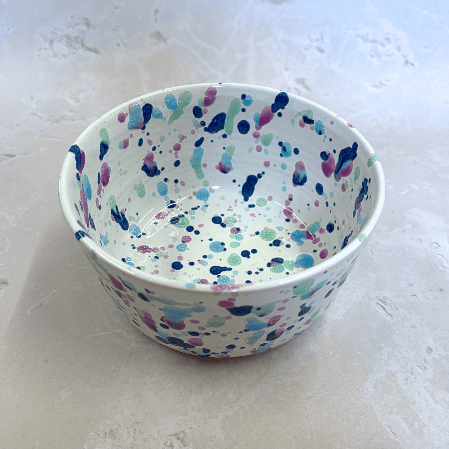 Ella Fletcher Designs Handmade Ceramic Ramen Bowl in Sweetpea Design, bowl with white background speckled with blues, pinks and greens