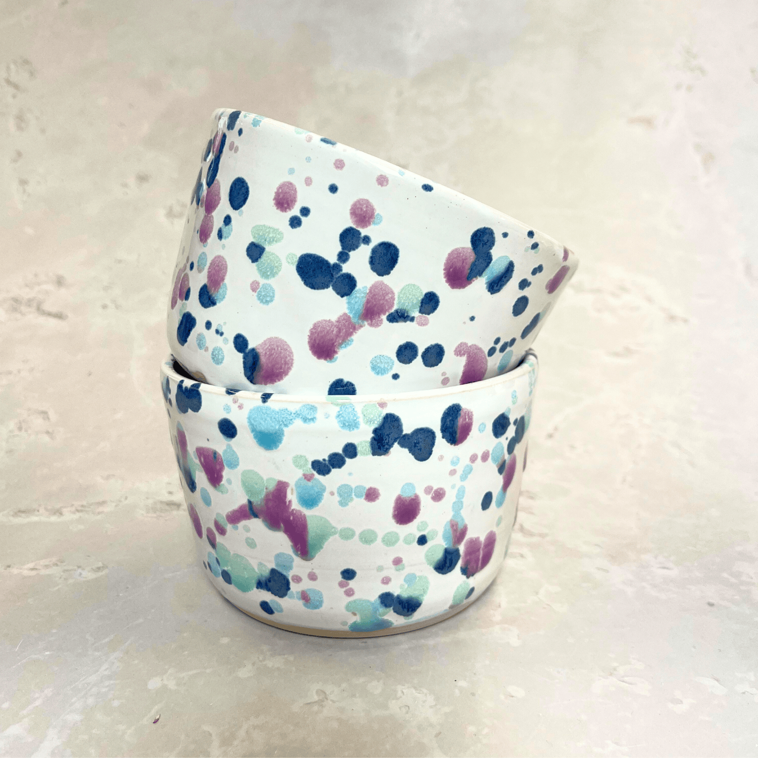 Ella Fletcher Designs Handmade Ceramic Small Bowl in Sweetpea, two bowls stacked with white background and splatters of blues and pink