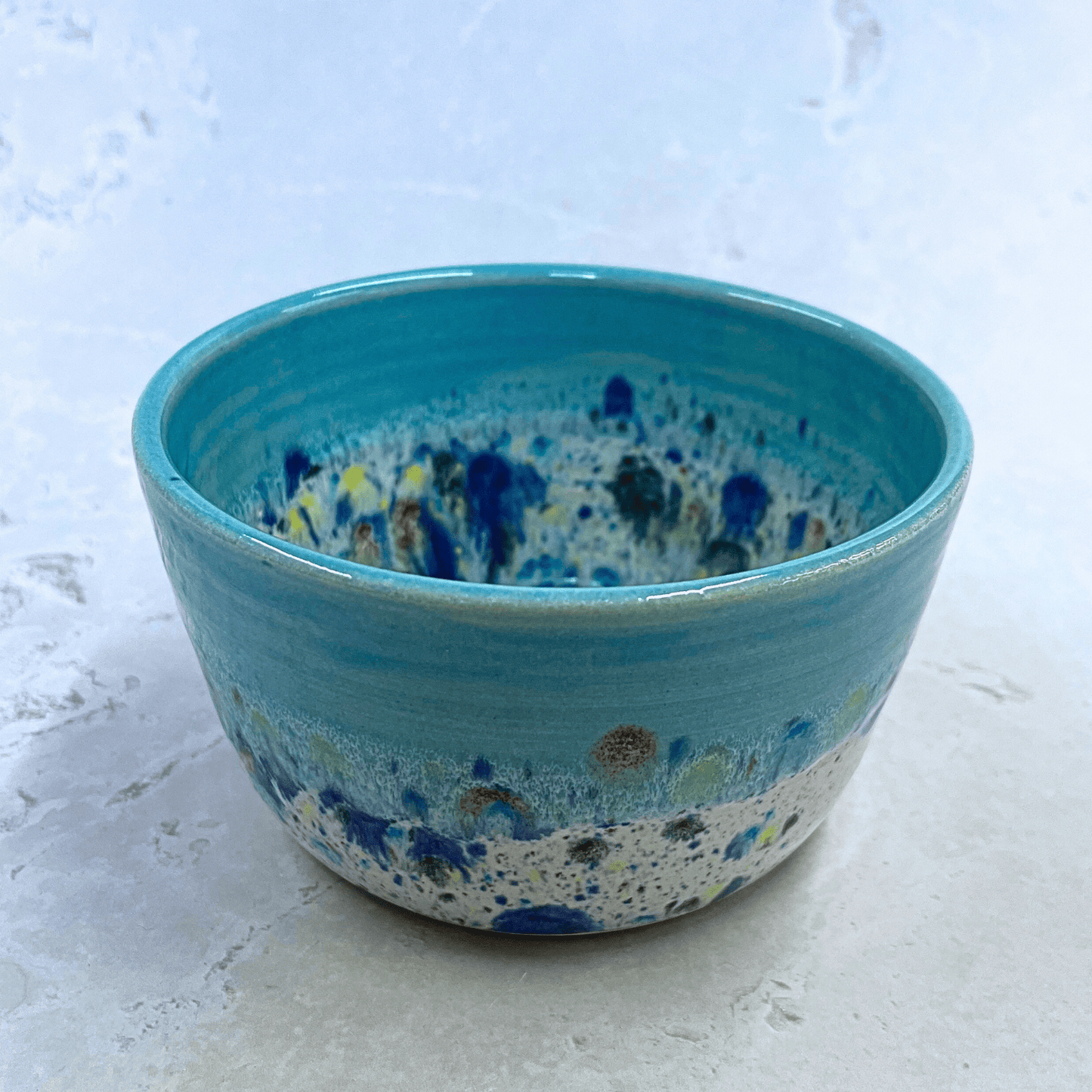 Ella Fletcher Designs Handmade Ceramics Small Bowl in Blue Shoreline design, round bowl with pale blue and multicolour speckles